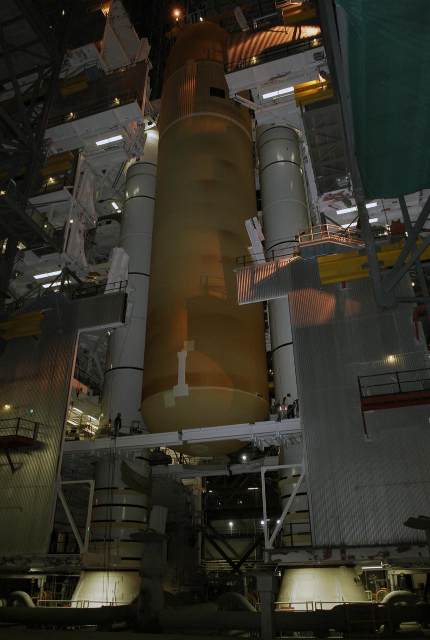 CAPE CANAVERAL, Fla. -- In the Vehicle Assembly Building at NASA's Kennedy Space Center, the external tank for space shuttle Discovery is being lowered into place in high bay 3 between the solid rocket boosters waiting on the mobile launcher platform. The tank will be mated to the boosters. Discovery is targeted to launch May 31 on the STS-124 mission to the International Space Station. On the mission, Discovery will transport the Kibo Japanese Experiment Module - Pressurized Module (JEM-PM) and the Japanese Remote Manipulator System (JEM-RMS) to the space station to add to the Kibo laboratory. Photo credit: NASA/Kim Shiflett