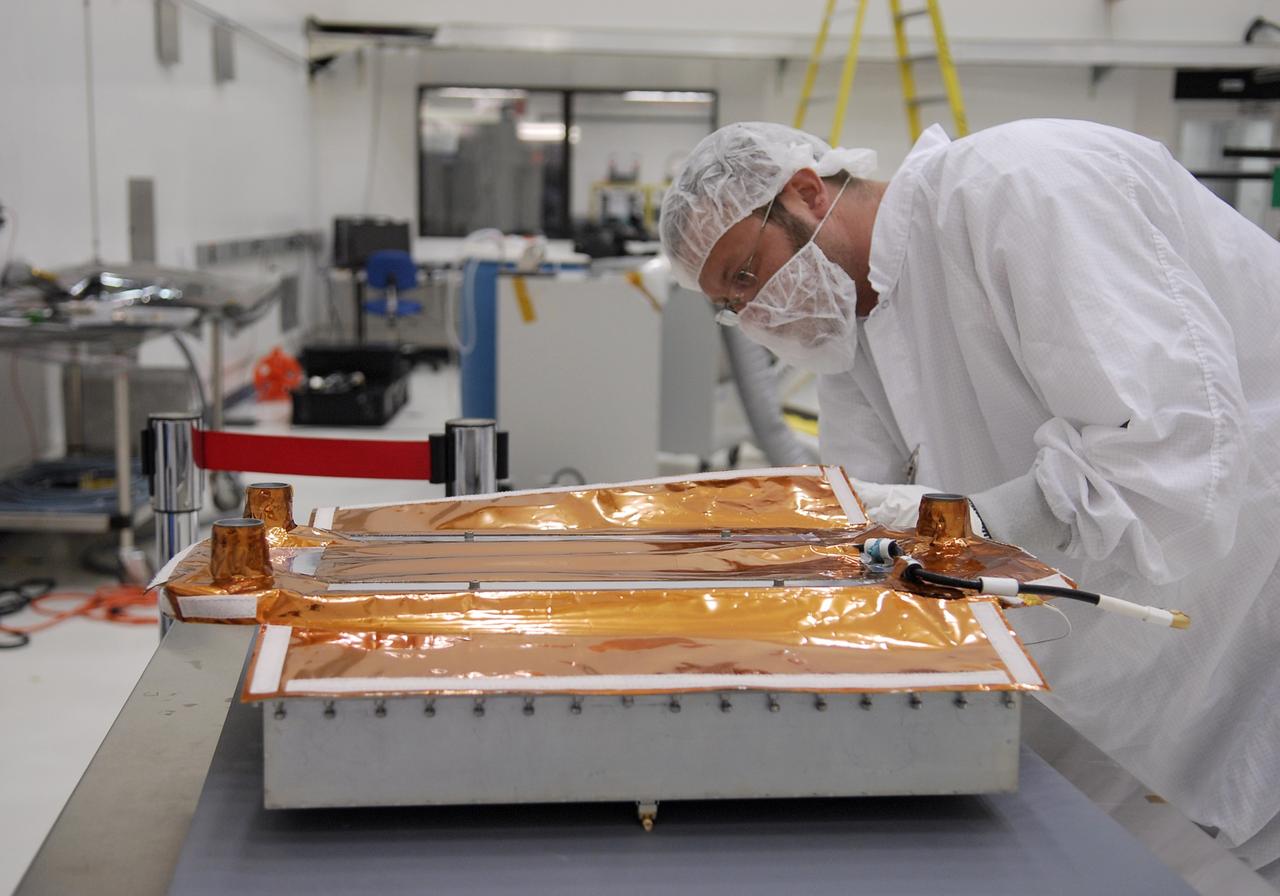 CAPE CANAVERAL, Fla. -- In the Astrotech payload processing facility near NASA's Kennedy Space Center, General Dynamics technicians prepare a high-gain antenna for installation on the Gamma-ray Large Area Space Telescope, or GLAST. The GLAST is a powerful space observatory that will explore the universe's ultimate frontier, where nature harnesses forces and energies far beyond anything possible on Earth; probe some of science's deepest questions, such as what our universe is made of, and search for new laws of physics; explain how black holes accelerate jets of material to nearly light speed; and help crack the mystery of stupendously powerful explosions known as gamma-ray bursts. Launch is currently planned in a window between 11:45 a.m. and 1:40 p.m. EDT May 16. Photo credit: NASA/Kim Shiflett