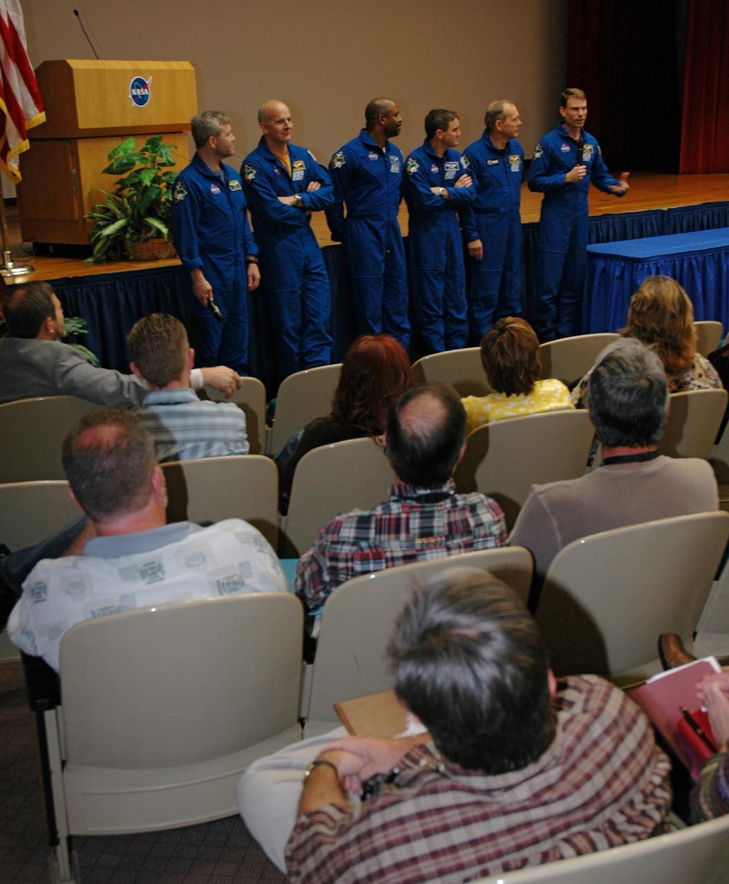 CAPE CANAVERAL, Fla. -- The STS-122 crew returns to NASA's Kennedy Space Center for a presentation in the Training Auditorium. Having completed their successful 13-day mission to the International Space Station, (from left) Commander Steve Frick, Pilot Alan Poindexter, and Mission Specialists Leland Melvin, Rex Walheim, Hans Schlegel and Stanley Love share personal stories, photos and videos of their challenging mission. Photo credit: NASA/Cory Huston