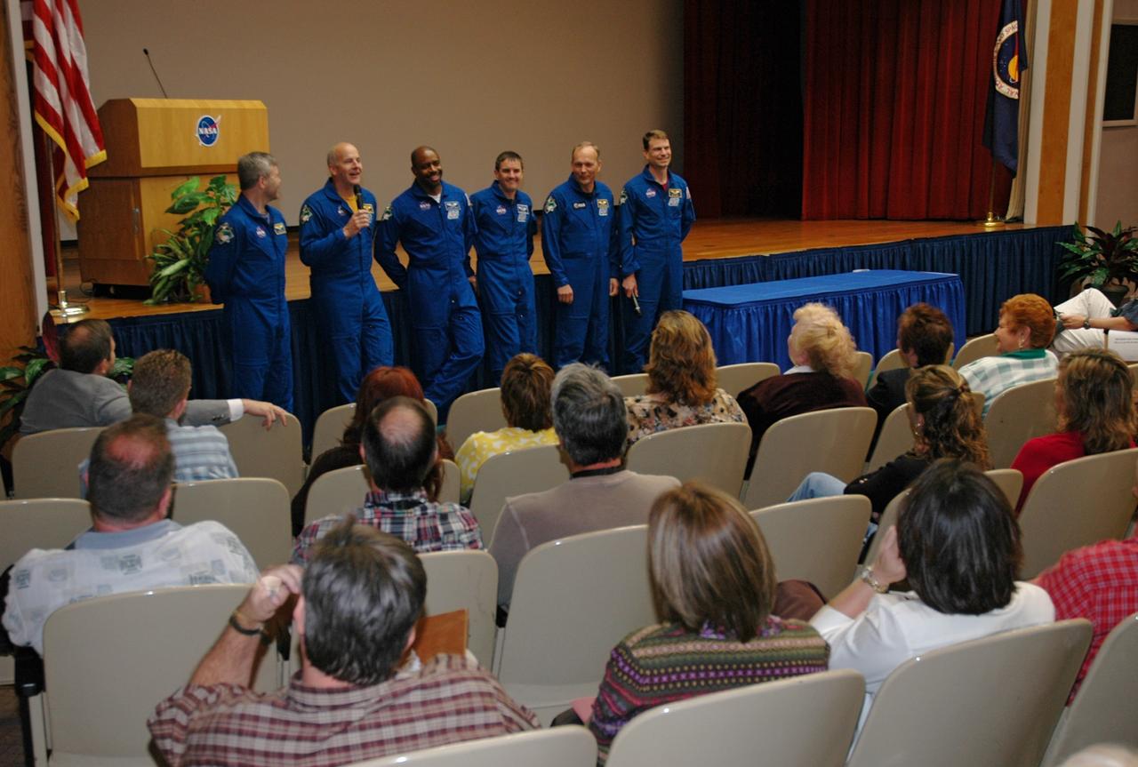 CAPE CANAVERAL, Fla. -- The STS-122 crew returns to NASA's Kennedy Space Center for a presentation in the Training Auditorium. Having completed their successful 13-day mission to the International Space Station, (from left) Commander Steve Frick, Pilot Alan Poindexter, and Mission Specialists Leland Melvin, Rex Walheim, Hans Schlegel and Stanley Love share personal stories, photos and videos of their challenging mission. Photo credit: NASA/Cory Huston