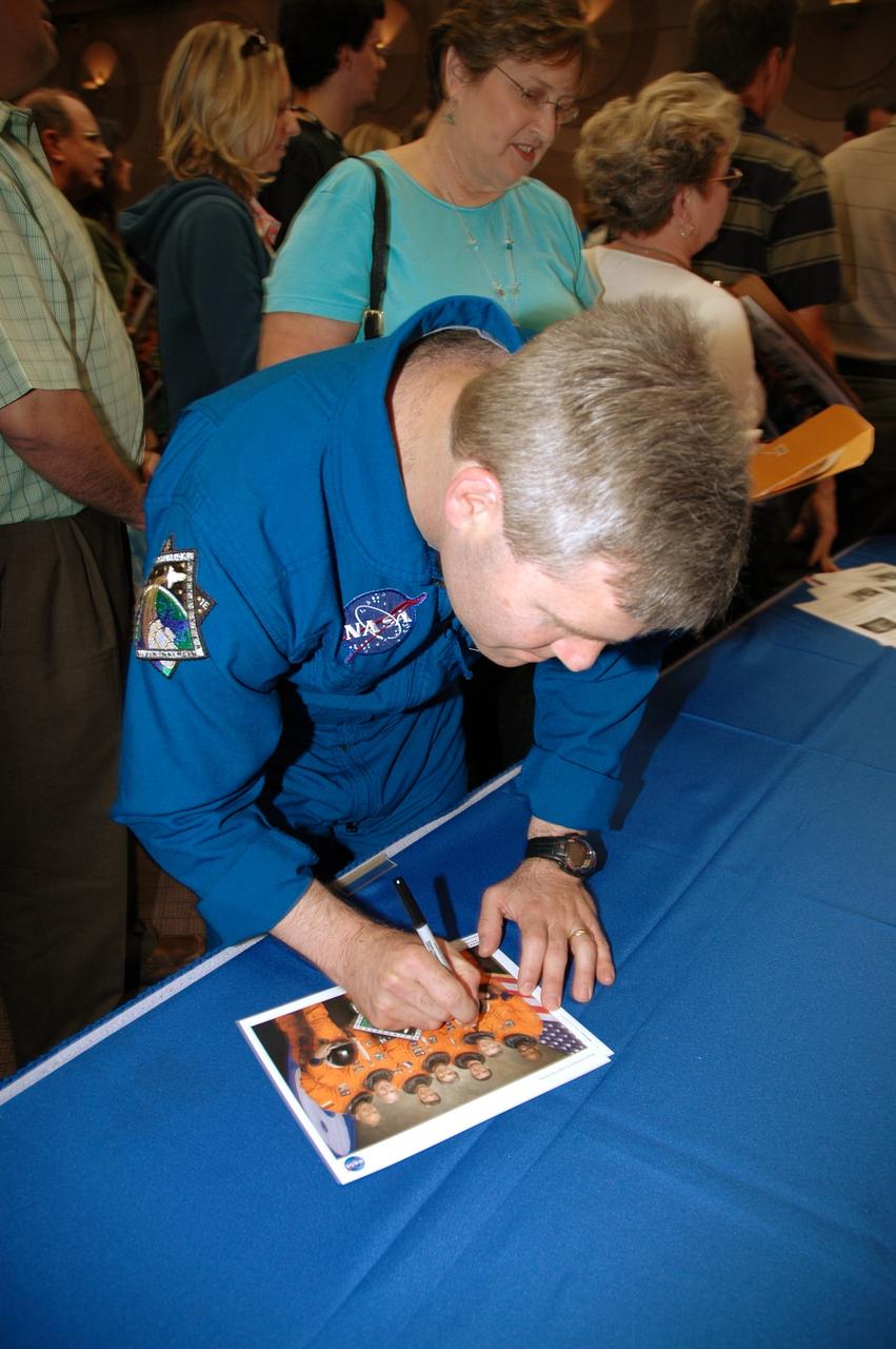 CAPE CANAVERAL, Fla. -- Following the presentation in the Training Auditorium at NASA's Kennedy Space Center, the STS-122 crew signs autographs for employees. At front is Commander Steven Frick. The crew members shared personal stories, photos and videos of their challenging mission. Photo credit: NASA/Cory Huston