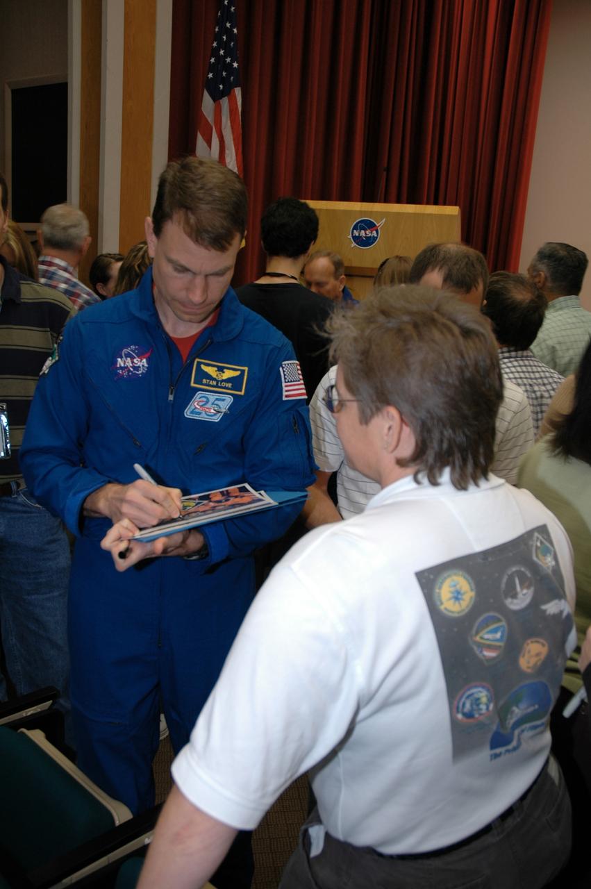 CAPE CANAVERAL, Fla. -- Following the presentation in the Training Auditorium at NASA's Kennedy Space Center, the STS-122 crew signs autographs for employees. At front is Mission Specialist Stan Love. The crew members shared personal stories, photos and videos of their challenging mission. Photo credit: NASA/Cory Huston
