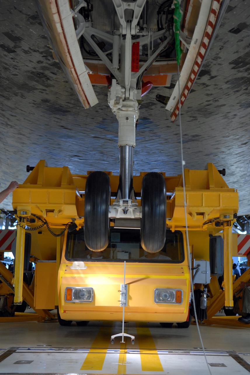 CAPE CANAVERAL, Fla. -- In Orbiter Processing Facility Bay 3 at NASA’s Kennedy Space Center, the Orbiter Transport System, or OTS, moves under the belly of space shuttle Discovery. The OTS will help move the orbiter on its rollover to the Vehicle Assembly Building. Discovery is targeted to launch May 31 on the STS-124 mission to the International Space Station. On the mission, Discovery will transport the Kibo Japanese Experiment Module - Pressurized Module (JEM-PM) and the Japanese Remote Manipulator System (JEM-RMS) to the space station to add to the Kibo laboratory. Photo credit: NASA/Troy Cryder