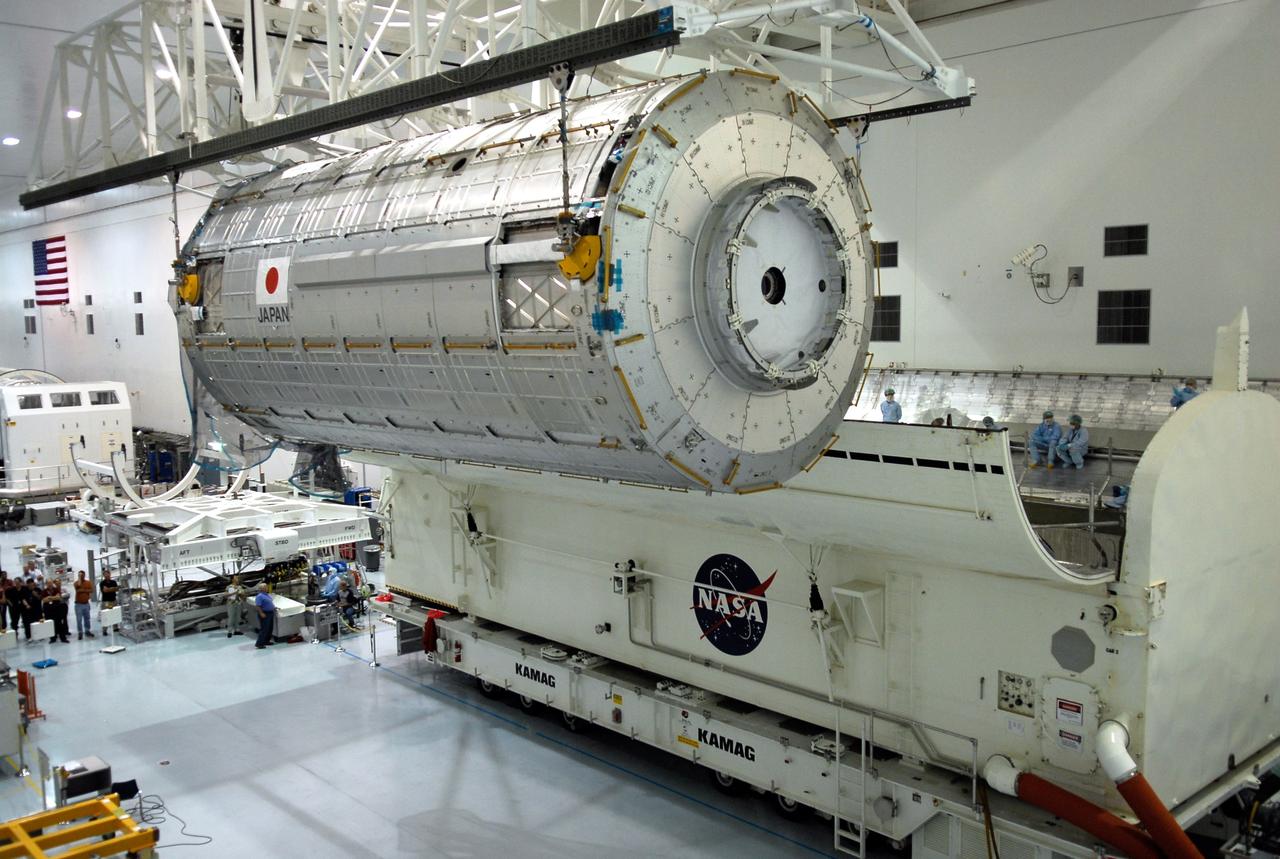 CAPE CANAVERAL, Fla. -- In the Space Station Processing Facility at NASA’s Kennedy Space Center, an overhead crane moves the Kibo Japanese Experiment Module - Pressurized Module toward the payload canister (lower right).  The canister will deliver the module, part of the payload for space shuttle Discovery’s STS-124 mission, to Launch Pad 39A.  On the mission, the STS-124 crew will transport the Kibo module as well as the Japanese Remote Manipulator System to the International Space Station to complete the Kibo laboratory.  The launch of Discovery is targeted for May 31.   Photo credit: NASA/Kim Shiflett