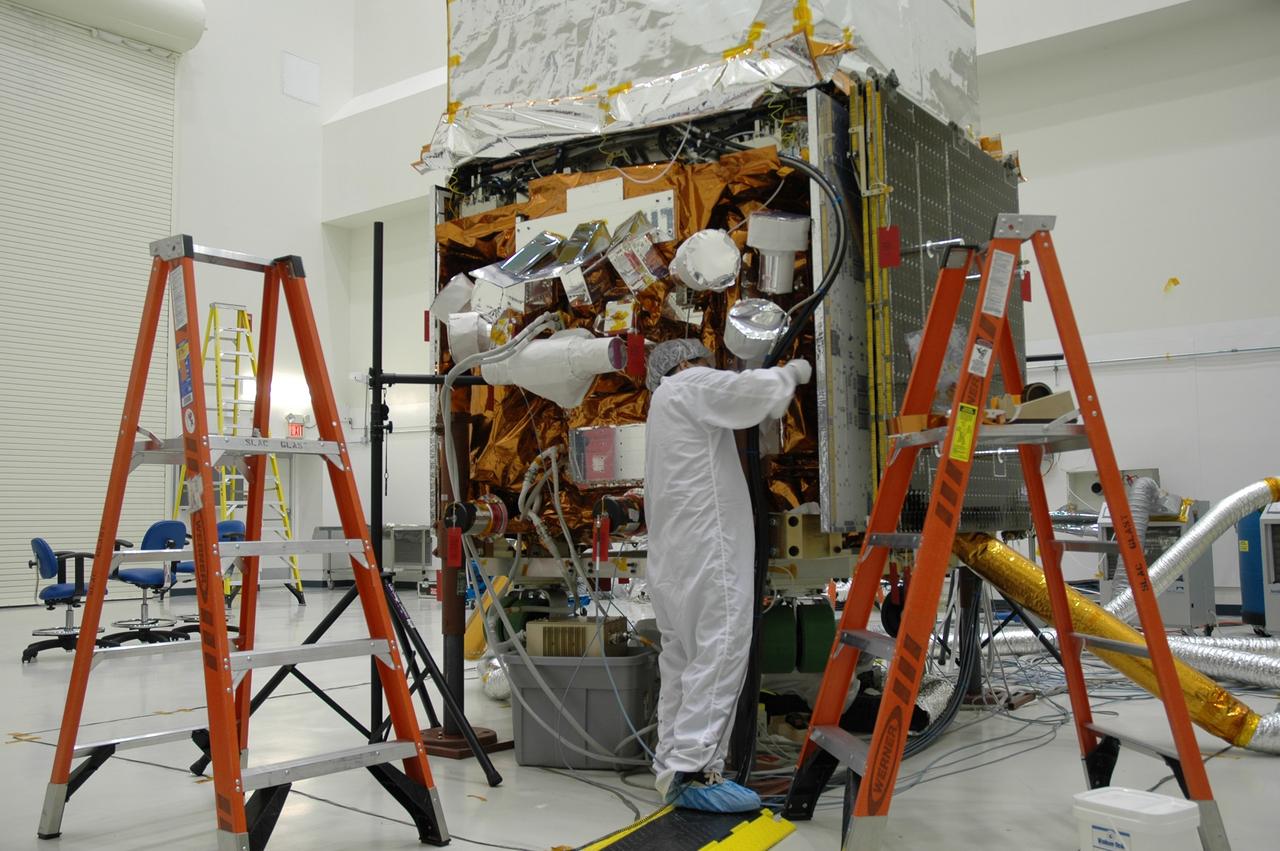CAPE CANAVERAL, Fla. -- At the Astrotech payload processing facility in Titusville, Fla., workers prepare NASA's Gamma-ray Large Area Space Telescope, or GLAST, spacecraft for star tracker sun shade installation. The GLAST is a powerful space observatory that will explore the Universe's ultimate frontier, where nature harnesses forces and energies far beyond anything possible on Earth; probe some of science's deepest questions, such as what our Universe is made of, and search for new laws of physics; explain how black holes accelerate jets of material to nearly light speed; and help crack the mystery of stupendously powerful explosions known as gamma-ray bursts. A launch date is still to be determined. Photo credit: NASA/Cory Huston