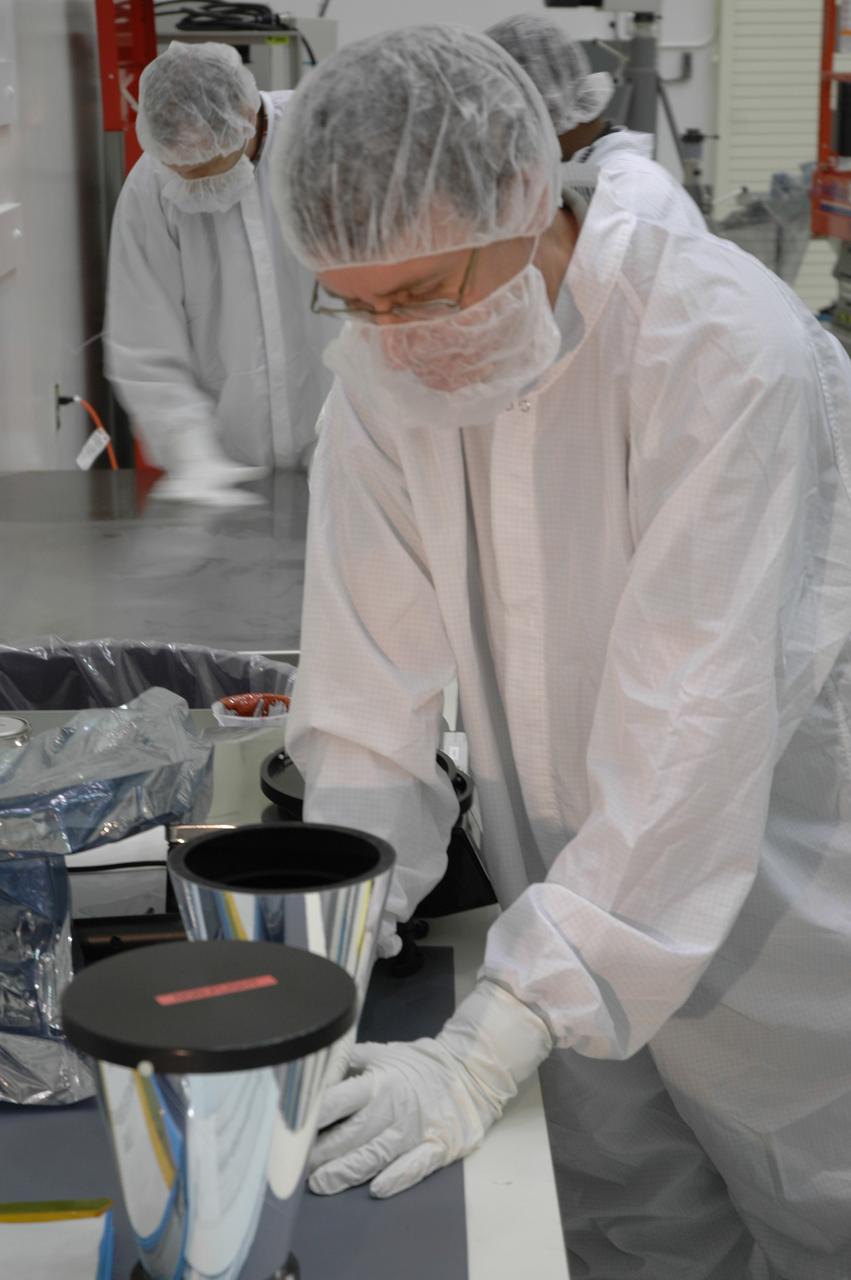 CAPE CANAVERAL, Fla. -- At the Astrotech payload processing facility in Titusville, Fla., workers prepare NASA's Gamma-ray Large Area Space Telescope, or GLAST, spacecraft for star tracker sun shade installation. The GLAST is a powerful space observatory that will explore the Universe's ultimate frontier, where nature harnesses forces and energies far beyond anything possible on Earth; probe some of science's deepest questions, such as what our Universe is made of, and search for new laws of physics; explain how black holes accelerate jets of material to nearly light speed; and help crack the mystery of stupendously powerful explosions known as gamma-ray bursts. A launch date is still to be determined. Photo credit: NASA/Cory Huston