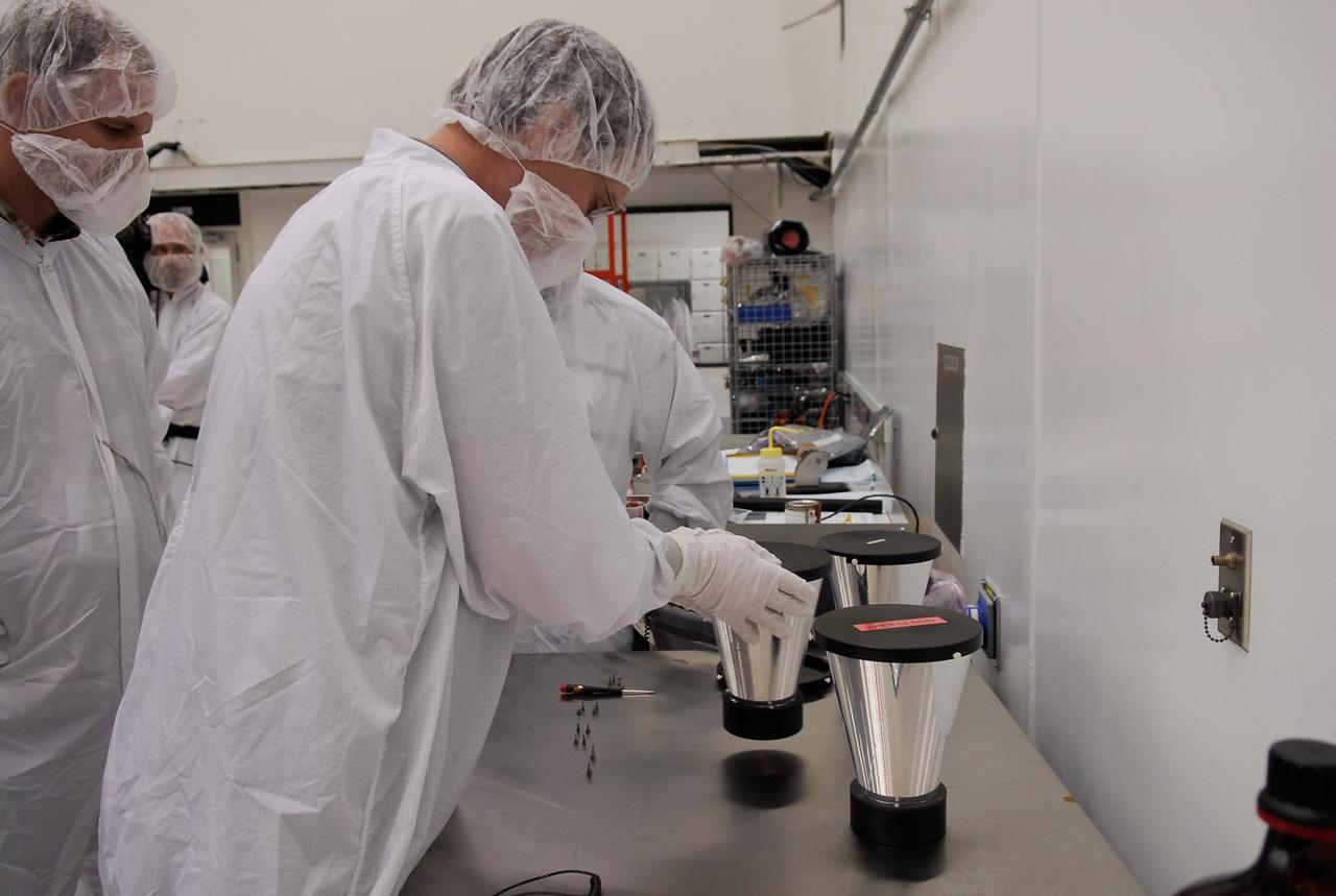 CAPE CANAVERAL, Fla. -- At the Astrotech payload processing facility in Titusville, Fla., a worker picks up one of the star tracker sun shades to install on NASA's Gamma-ray Large Area Space Telescope, or GLAST, spacecraft. The GLAST is a powerful space observatory that will explore the Universe's ultimate frontier, where nature harnesses forces and energies far beyond anything possible on Earth; probe some of science's deepest questions, such as what our Universe is made of, and search for new laws of physics; explain how black holes accelerate jets of material to nearly light speed; and help crack the mystery of stupendously powerful explosions known as gamma-ray bursts. A launch date is still to be determined. Photo credit: NASA/Kim Shiflett
