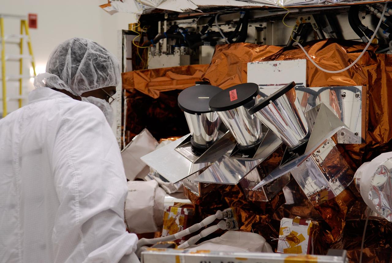 CAPE CANAVERAL, Fla. -- At the Astrotech payload processing facility in Titusville, Fla., a worker looks over the star tracker sun shades installed on NASA's Gamma-ray Large Area Space Telescope, or GLAST, spacecraft. The GLAST is a powerful space observatory that will explore the Universe's ultimate frontier, where nature harnesses forces and energies far beyond anything possible on Earth; probe some of science's deepest questions, such as what our Universe is made of, and search for new laws of physics; explain how black holes accelerate jets of material to nearly light speed; and help crack the mystery of stupendously powerful explosions known as gamma-ray bursts. A launch date is still to be determined. Photo credit: NASA/Kim Shiflett