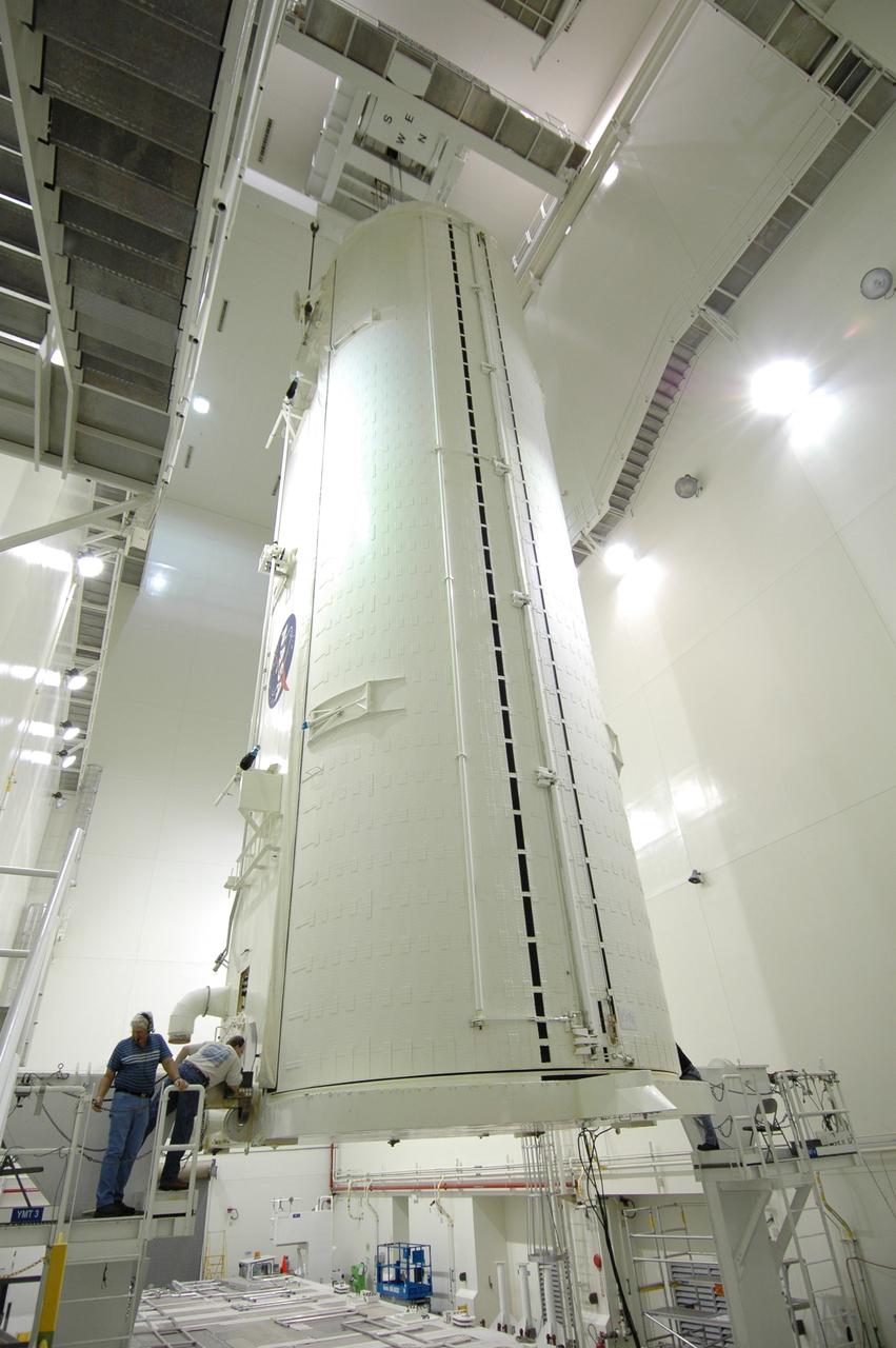 CAPE CANAVERAL, Fla. -- In the Vertical Integration Facility at NASA's Kennedy Space Center, workers on either side of the payload canister check its condition after being rotated from a horizontal position. The canister contains the Japanese Experiment Module -Pressurized Module, which will be transported to Launch Pad 39A for space shuttle Discovery’s STS-124 mission.   At the pad, the payload will be transferred from the canister into the payload changeout room on the rotating service structure.  The changeout room is the enclosed, environmentally controlled portion of the service structure that supports cargo delivery to the pad and subsequent vertical installation into an orbiter's payload bay. On the mission, the STS-124 crew will transport the JEM as well as the Japanese Remote Manipulator System to the International Space Station.  The launch of Discovery is targeted for May 31.    Photo credit: NASA/Jim Grossmann