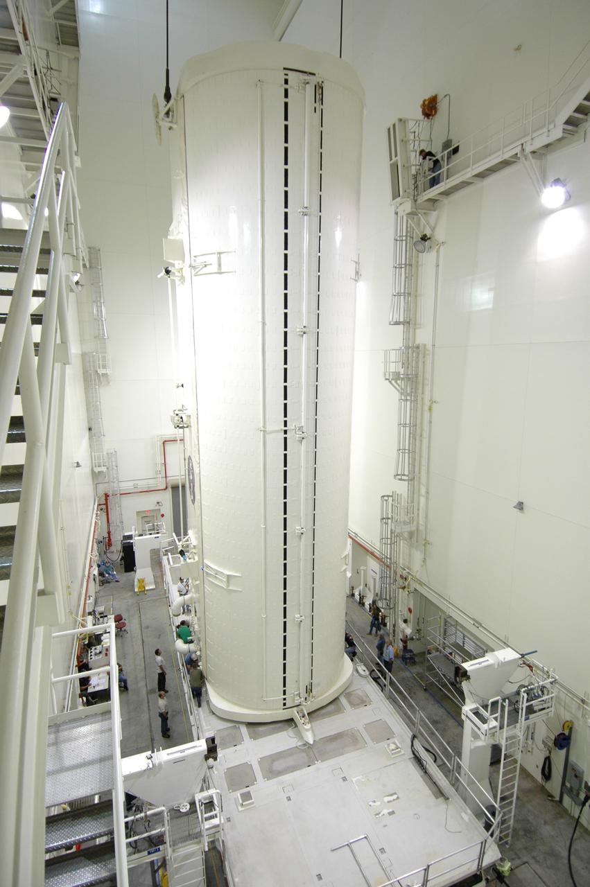 CAPE CANAVERAL, Fla. -- In the Vertical Integration Facility at NASA's Kennedy Space Center, workers check the placement of the payload canister after it was lowered onto the payload canister transporter.  The canister contains the Japanese Experiment Module -Pressurized Module, which will be transported to Launch Pad 39A for space shuttle Discovery’s STS-124 mission. At the pad, the payload will be transferred from the canister into the payload changeout room on the rotating service structure.  The changeout room is the enclosed, environmentally controlled portion of the service structure that supports cargo delivery to the pad and subsequent vertical installation into an orbiter's payload bay. On the mission, the STS-124 crew will transport the JEM as well as the Japanese Remote Manipulator System to the International Space Station.  The launch of Discovery is targeted for May 31.    Photo credit: NASA/Jim Grossmann