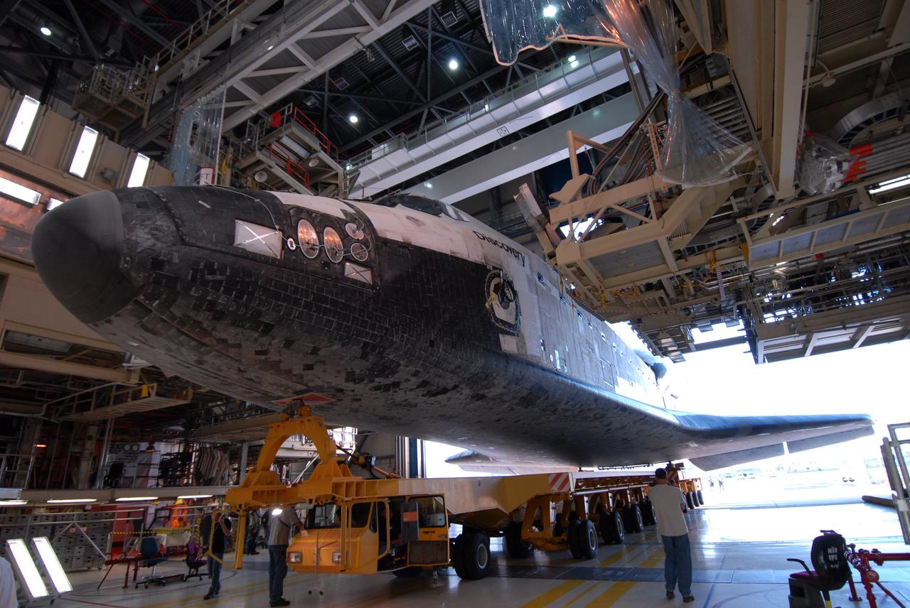 CAPE CANAVERAL, Fla. --  Space shuttle Discovery rolls out from the Orbiter Processing Facility for the short trip to the Vehicle Assembly Building, or VAB, at NASA's Kennedy Space Center. It rests on the orbiter transporter system, which has 76 wheels and measures 106.5 feet long.  In high bay 3 of the VAB, Discovery will be attached to its external fuel tank and solid rocket boosters in preparation for its upcoming STS-124 mission to the International Space Station. On the mission, the STS-124 crew will transport the Japanese Experiment Module - Pressurized Module and the Japanese Remote Manipulator System to the space station.  Launch of Discovery is targeted for May 31. Photo credit: NASA/Troy Cryder