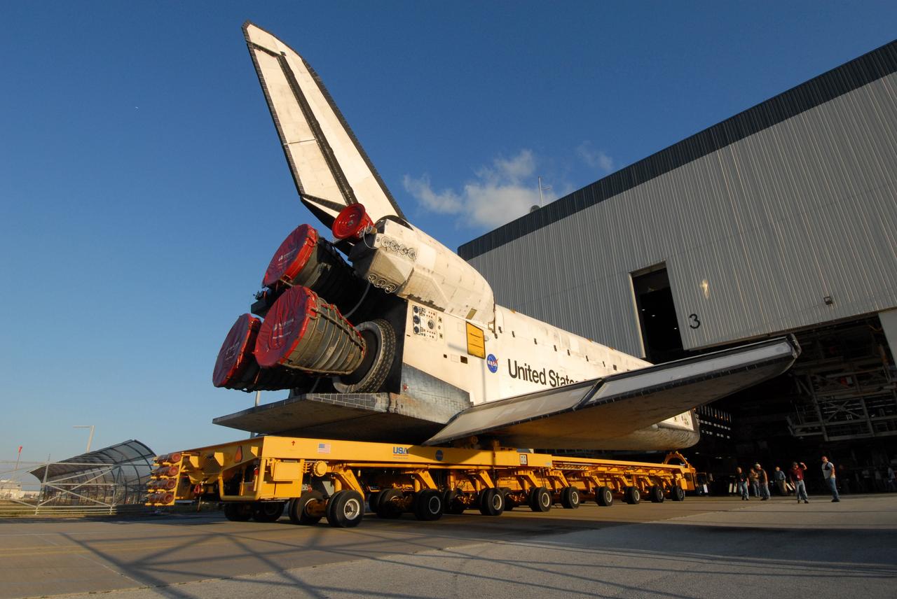 CAPE CANAVERAL, Fla. --  Space shuttle Discovery rolls away from the Orbiter Processing Facility on its 76-wheeled orbiter transporter to make the short trip to the Vehicle Assembly Building, or VAB, at NASA's Kennedy Space Center.  The transporter is 106.5 feet long. In high bay 3 of the VAB, Discovery will be attached to its external fuel tank and solid rocket boosters in preparation for its upcoming STS-124 mission to the International Space Station.  On the mission, the STS-124 crew will transport the Japanese Experiment Module - Pressurized Module and the Japanese Remote Manipulator System to the space station.  Launch of Discovery is targeted for May 31. Photo credit: NASA/Troy Cryder