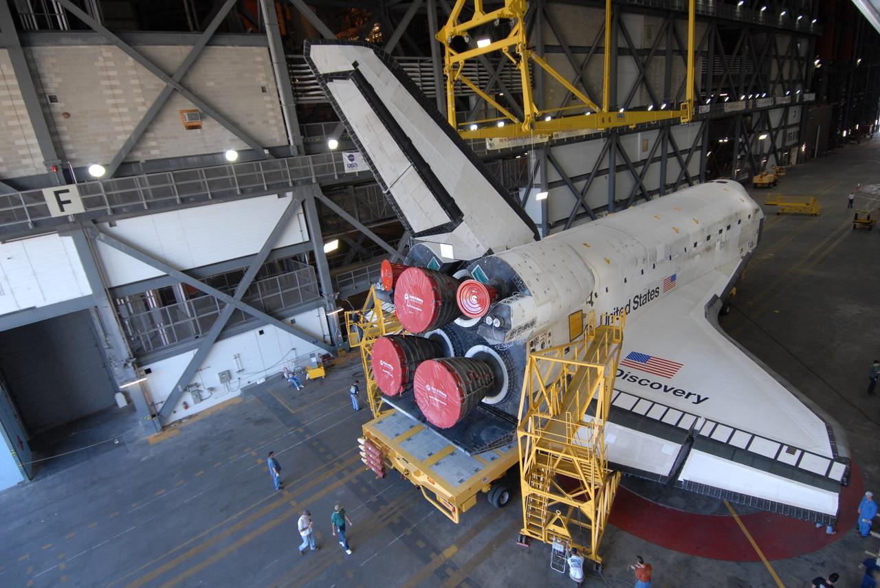 CAPE CANAVERAL, Fla. --   Still on its 76-wheeled orbiter transporter, space shuttle Discovery rests in the transfer aisle of the Vehicle Assembly Building at NASA's Kennedy Space Center.  Discovery will be raised from the transporter to a vertical position and lifted into high bay 3.  In the bay it will be attached  to its external fuel tank and solid rocket boosters in preparation for its upcoming STS-124 mission to the International Space Station.  On the mission, the STS-124 crew will transport the Japanese Experiment Module - Pressurized Module and the Japanese Remote Manipulator System to the space station.  Launch of Discovery is targeted for May 31. Photo credit: NASA/Troy Cryder