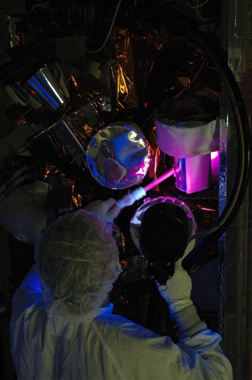 CAPE CANAVERAL, Fla. –  At the Astrotech payload processing facility, technicians conduct black light inspection on NASA's Gamma-ray Large Area Space Telescope, or GLAST,  spacecraft. The GLAST is a powerful space observatory that will explore the Universe's ultimate frontier, where nature harnesses forces and energies far beyond anything possible on Earth;  probe some of science's deepest questions, such as what our Universe is made of, and search for new laws of physics; explain how black holes accelerate jets of material to nearly light speed; and help crack the mystery of stupendously powerful explosions known as gamma-ray bursts. A launch date is still to be determined.   Photo credit: NASA/Jim Grossmann