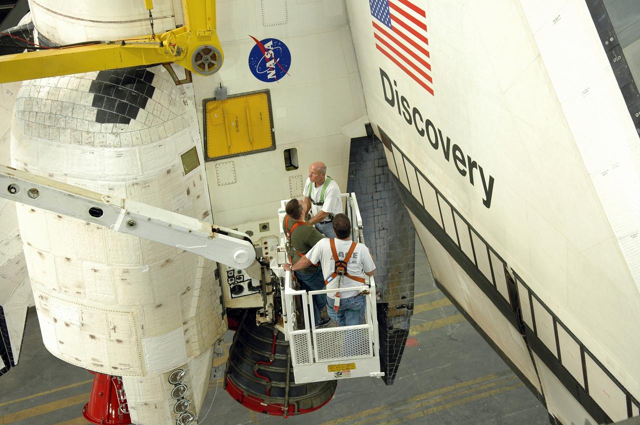 CAPE CANAVERAL, Fla. --   In the Vehicle Assembly Building at NASA's Kennedy Space Center, United Space Alliance technicians check the crane attached to space shuttle Discovery.  The crane will lift Discovery to the upper levels and lower it into high bay 3.  In the bay, Discovery will be mated to the external tank and solid rocket boosters for launch on the upcoming STS-124 mission to the International Space Station. On the mission, the STS-124 crew will transport the Japanese Experiment Module - Pressurized Module and the Japanese Remote Manipulator System to the space station.  Launch of Discovery is targeted for May 31 Photo credit: NASA/Jim Grossmann