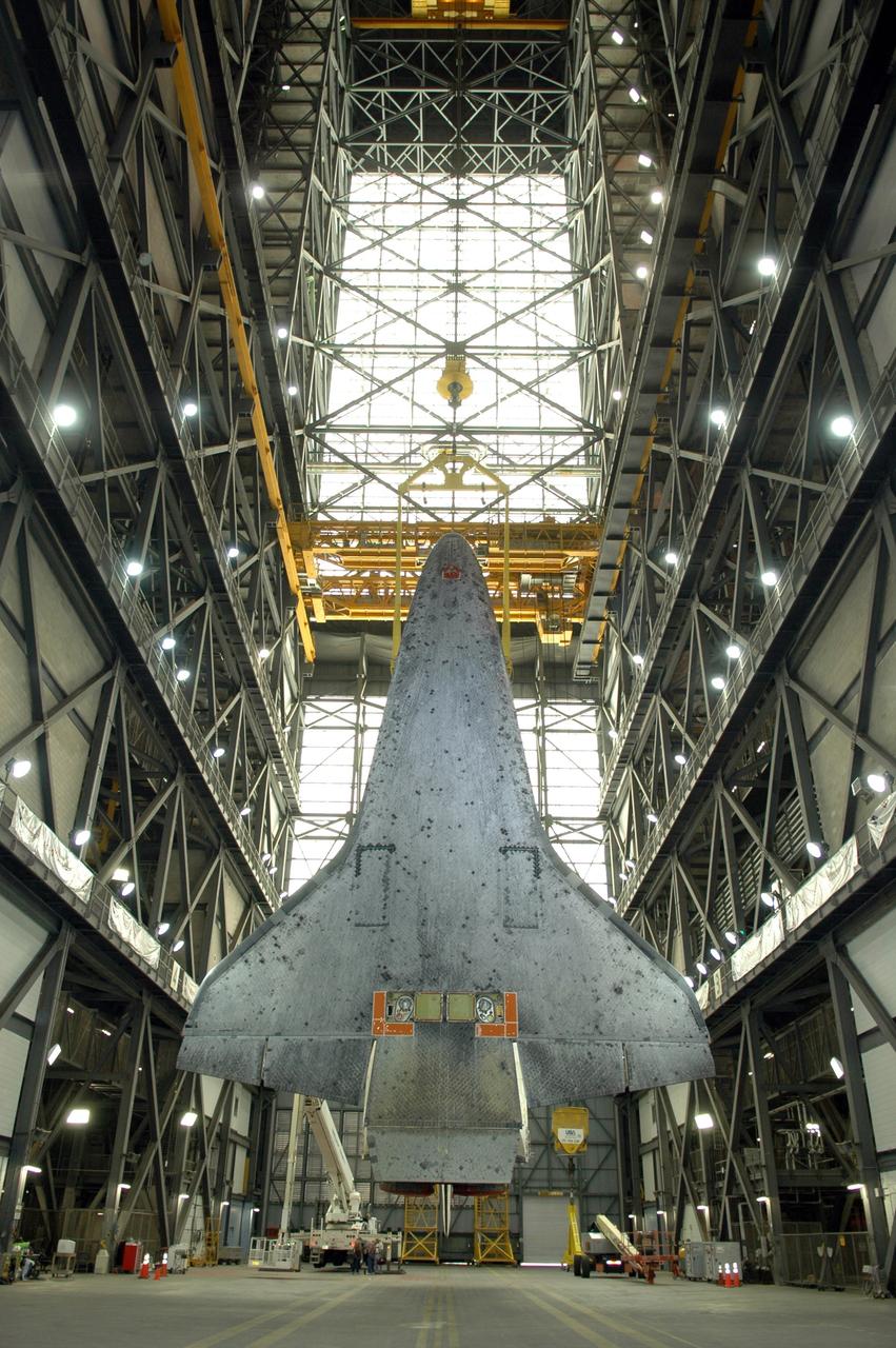 CAPE CANAVERAL, Fla. --  In the Vehicle Assembly Building at NASA's Kennedy Space Center, space shuttle Discovery, looking like a giant bat, hangs suspended above the transfer aisle.  The crane holding it will lift Discovery to the upper levels and lower it into high bay 3.  In the bay, Discovery will be mated to the external tank and solid rocket boosters for launch on the upcoming STS-124 mission to the International Space Station.  On the mission, the STS-124 crew will transport the Japanese Experiment Module - Pressurized Module and the Japanese Remote Manipulator System to the space station.  Launch of Discovery is targeted for May 31 Photo credit: NASA/Jim Grossmann