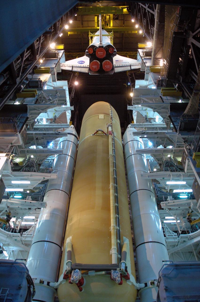 CAPE CANAVERAL, Fla. -- In high bay 3 of the Vehicle Assembly Building at NASA's Kennedy Space Center, a crane lowers space shuttle Discovery toward the external tank and solid rocket boosters already stacked on the mobile launcher platform. The stacking and mating are in preparation for the launch on the upcoming STS-124 mission to the International Space Station. On the mission, the STS-124 crew will transport the Japanese Experiment Module - Pressurized Module and the Japanese Remote Manipulator System to the space station. Launch of Discovery is targeted for May 31 Photo credit: NASA/Jim Grossmann