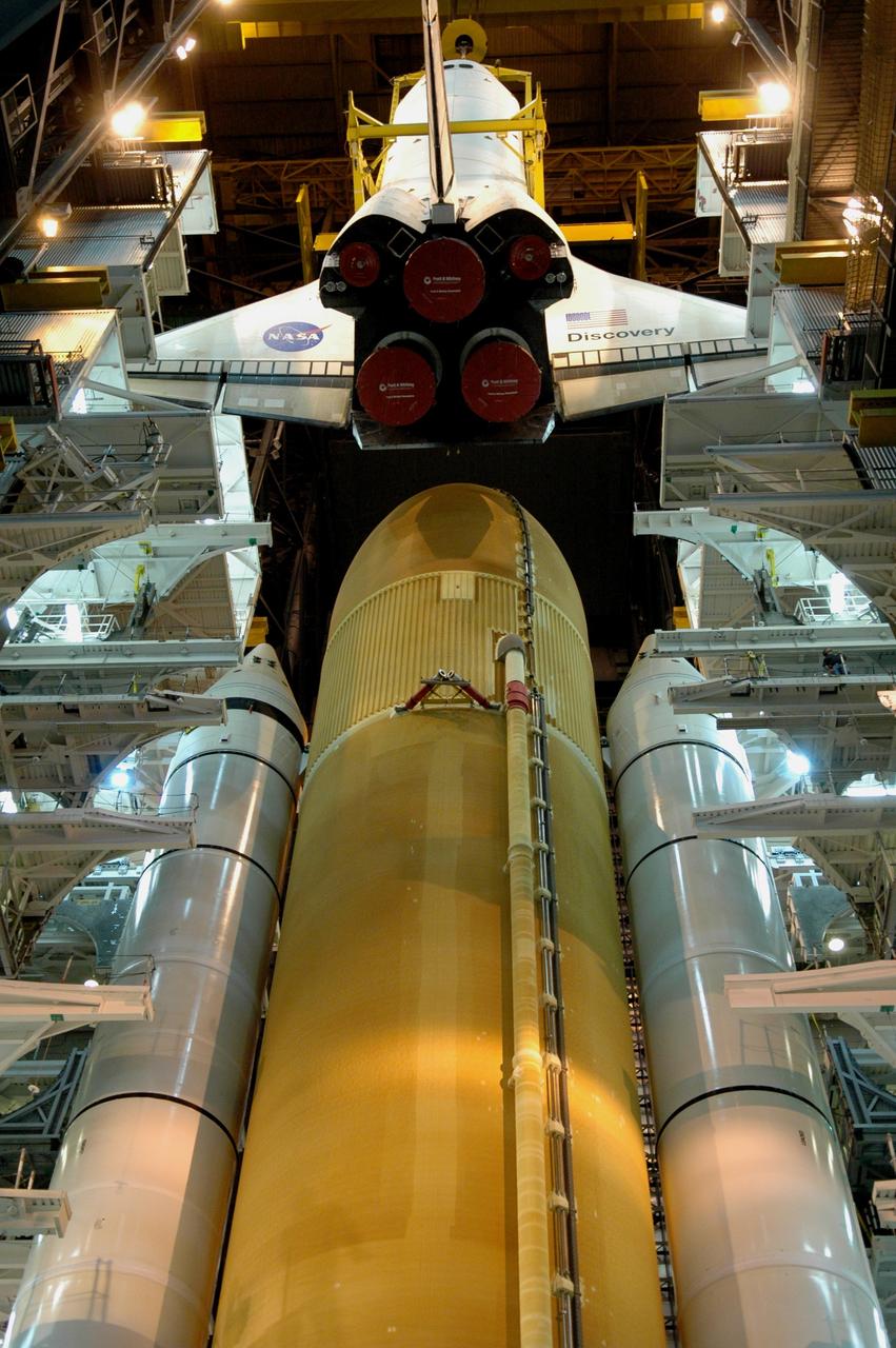 CAPE CANAVERAL, Fla. – In high bay 3 of the Vehicle Assembly Building at NASA's Kennedy Space Center, a crane lowers space shuttle Discovery toward the external tank and solid rocket boosters already stacked on the mobile launcher platform.  The stacking and mating are in preparation for the launch on the upcoming STS-124 mission to the International Space Station.   On the mission, the STS-124 crew will transport the Japanese Experiment Module - Pressurized Module and the Japanese Remote Manipulator System to the space station.  Launch of Discovery is targeted for May 31 Photo credit: NASA/Jim Grossmann
