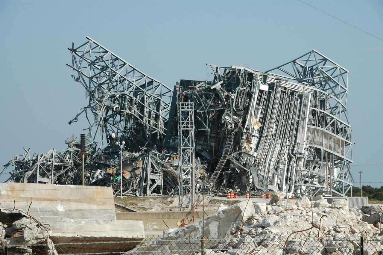 CAPE CANAVERAL, Fla. – Layers of twisted metal remain after demolition April 27 of the mobile service tower, or gantry, at Space Launch Complex 40 on Cape Canaveral Air Force Station.  This mammoth structure, with its cavernous clean room, was imploded to make room for the construction of launch pad access and servicing facilities for the new Falcon rockets to be launched by Space Exploration Technologies, known as SpaceX.  The gantry was used for the final spacecraft launch preparations for NASA’s Cassini spacecraft, currently orbiting Saturn.  The launch occurred on Oct. 15, 1997, aboard an Air Force Titan IV-Centaur rocket.  Photo credit: NASA/Jim Grossmann