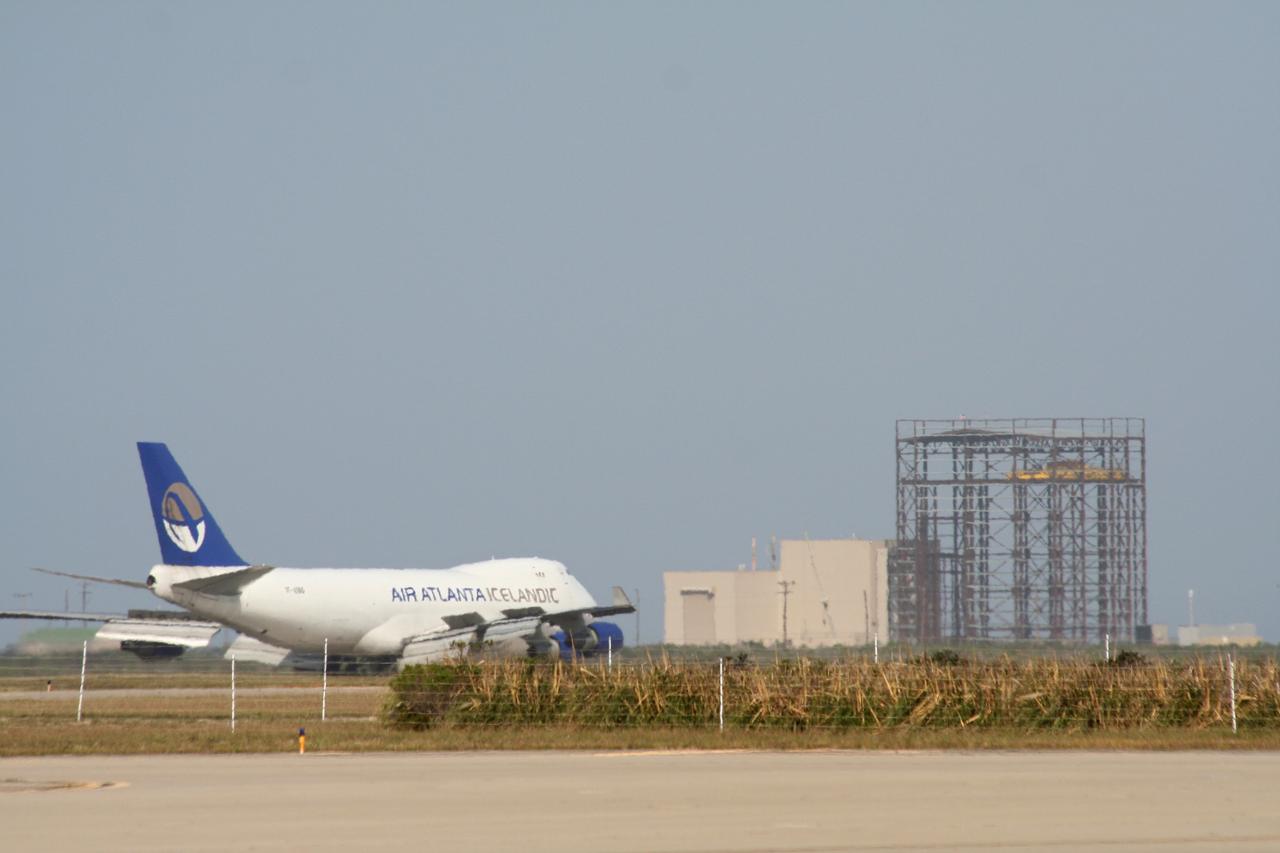 VANDENBERG AIR FORCE BASE, Calif.  –  The aircraft carrying the OSTM/Jason-2 spacecraft taxis past the Astrotech processing facility at Vandenberg Air Force Base in California.   The OSTM, or Ocean Topography Mission, on the Jason-2 satellite is a follow-on to Jason-1. It will take oceanographic studies of sea surface height into an operational mode for continued climate forecasting research and science and industrial applications.  This satellite altimetry data will help determine ocean circulation, climate change and sea-level rise. OSTM is a joint effort by the National Oceanic and Atmospheric Administration, NASA, France’s Centre National d’Etudes Spatiales and the European Meteorological Satellite Organisation. OSTM/Jason-2 will be launched aboard a United Launch Alliance Delta II 7320 from Vandenberg on June 15.  Photo credit: NASA/Stephen Greenberg, JPL