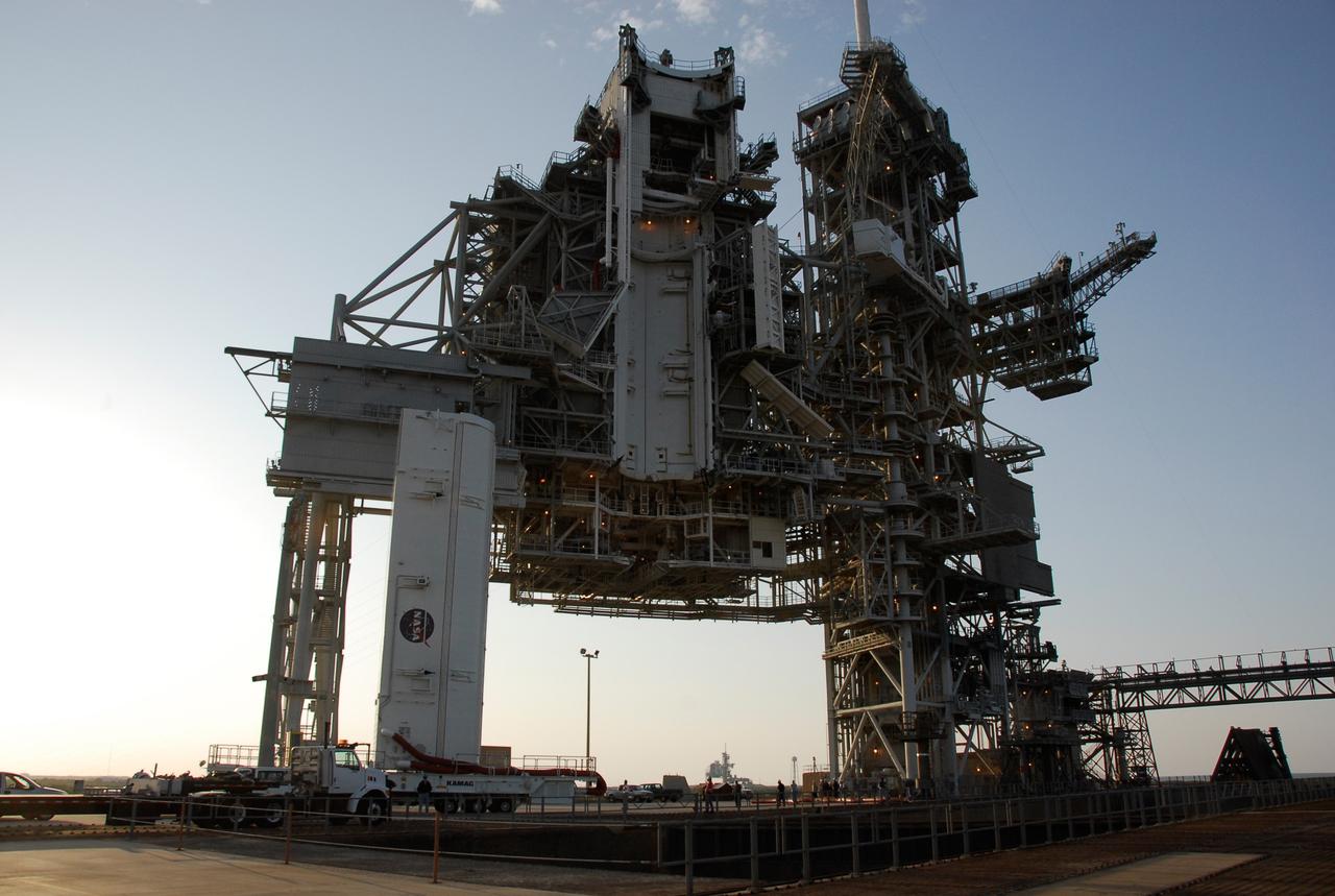 CAPE CANAVERAL, Fla. –   On Launch Pad 39A at NASA's Kennedy Space Center, the payload canister approaches the waiting payload changeout room in the rotating service structure.  The canister will be lifted up to the changeout room and the payload transferred inside.  The changeout room is the enclosed, environmentally controlled portion of the service structure that supports cargo delivery to the pad and subsequent vertical installation into an orbiter's payload bay.  From the payload changeout room, the pressurized module and RMS then will be transferred into space shuttle Discovery’s payload bay.  Launch is targeted for May 31.  Photo credit: NASA/Kim Shiflett