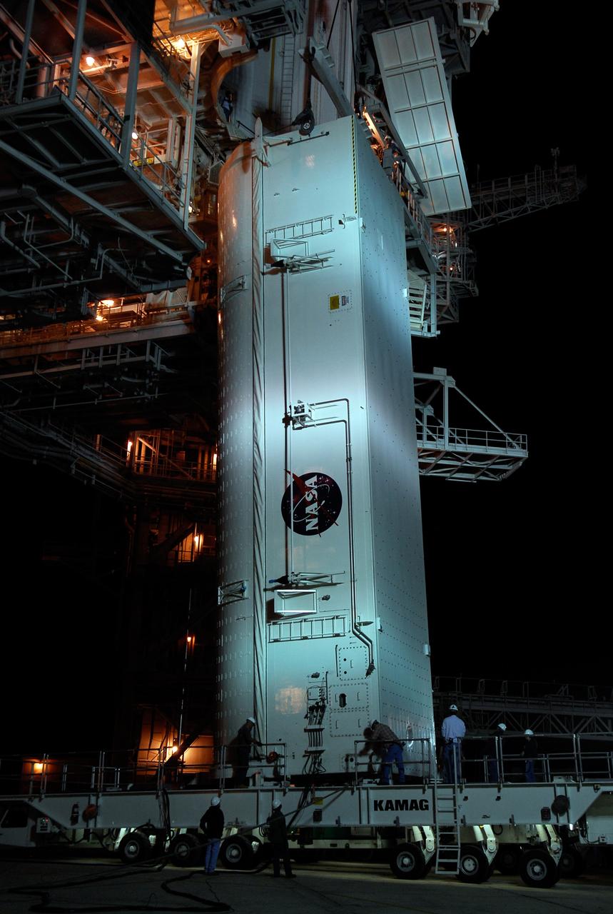 CAPE CANAVERAL, Fla. –    On Launch Pad 39A at NASA's Kennedy Space Center, workers on the payload canister transporter prepare for the lifting of the payload canister to the waiting payload changeout room above.  Inside the canister are the Japanese Experiment Module - Pressurized Module and the Japanese Remote Manipulator System, or RMS, for the STS-124 mission. The changeout room is the enclosed, environmentally controlled portion of the service structure that supports cargo delivery to the pad and subsequent vertical installation into an orbiter's payload bay.  From the payload changeout room, the pressurized module and RMS then will be transferred into space shuttle Discovery’s payload bay.  Launch is targeted for May 31.  Photo credit: NASA/Kim Shiflett