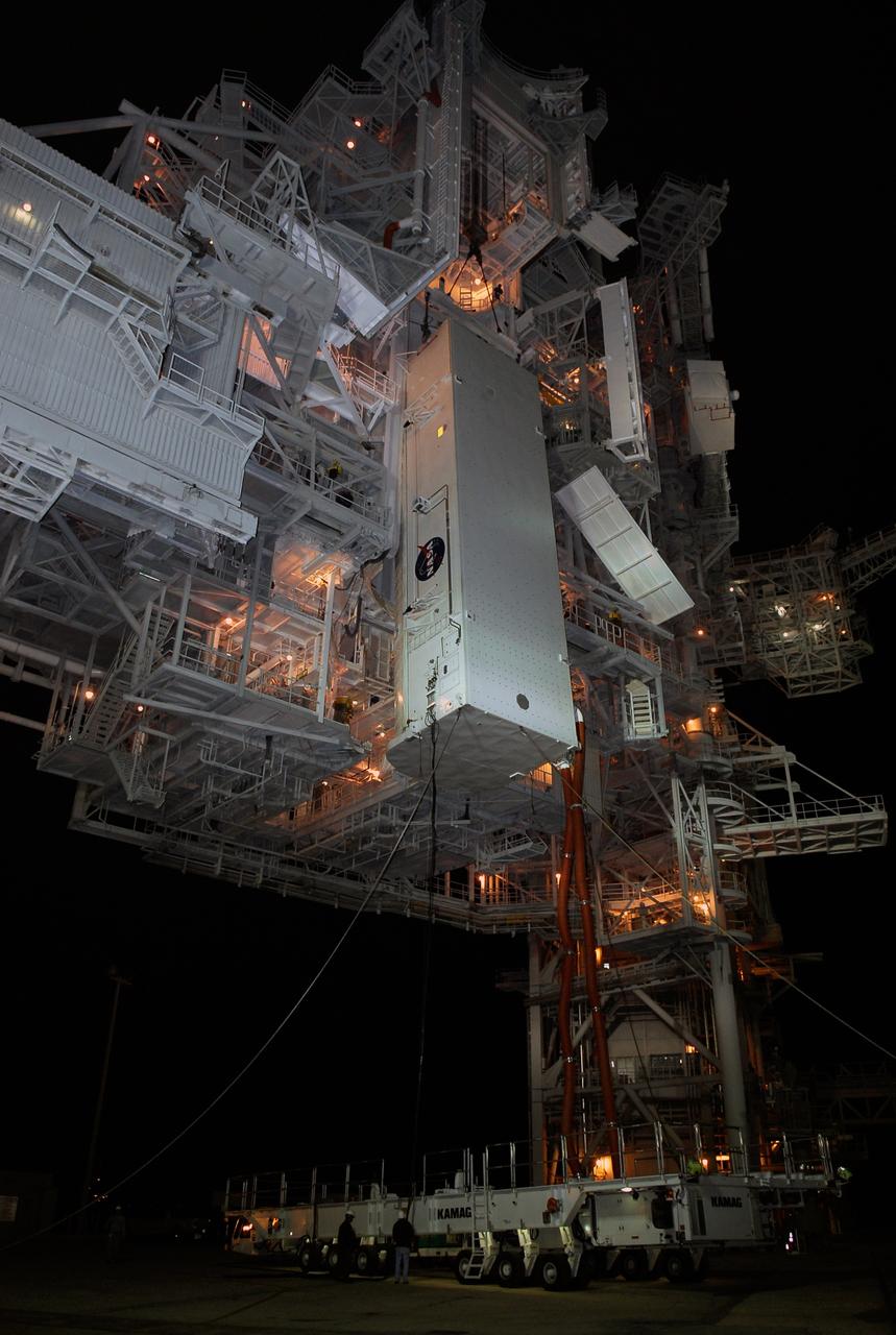 CAPE CANAVERAL, Fla. –   On Launch Pad 39A at NASA's Kennedy Space Center, the payload canister has been lifted up to the payload changeout room for transfer of its cargo.  Inside the canister are the Japanese Experiment Module - Pressurized Module and the Japanese Remote Manipulator System, or RMS, for the STS-124 mission. The changeout room is the enclosed, environmentally controlled portion of the service structure that supports cargo delivery to the pad and subsequent vertical installation into an orbiter's payload bay. From the payload changeout room, the pressurized module and RMS then will be transferred into space shuttle Discovery’s payload bay.  Launch is targeted for May 31.  Photo credit: NASA/Kim Shiflett
