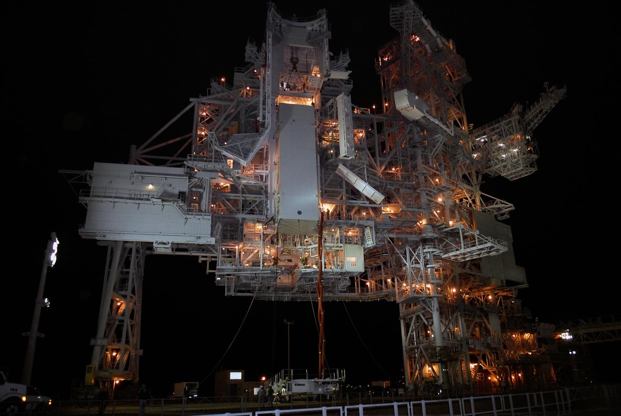 CAPE CANAVERAL, Fla. –   On Launch Pad 39A at NASA's Kennedy Space Center, the payload canister has been lifted up to the payload changeout room for transfer of its cargo.  Inside the canister are the Japanese Experiment Module - Pressurized Module and the Japanese Remote Manipulator System, or RMS, for the STS-124 mission. The changeout room is the enclosed, environmentally controlled portion of the service structure that supports cargo delivery to the pad and subsequent vertical installation into an orbiter's payload bay.  From the payload changeout room, the pressurized module and RMS then will be transferred into space shuttle Discovery’s payload bay.  Launch is targeted for May 31.  Photo credit: NASA/Kim Shiflett