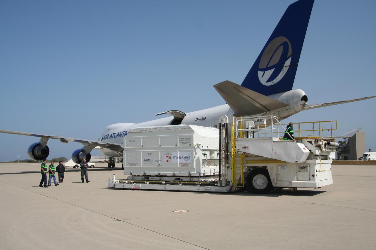 VANDENBERG AIR FORCE BASE, Calif.  –  After being offloaded from the cargo plane, the shipping container holding the OSTM/Jason-2 satellite is moved away from the plane.  The satellite will be taken to the Astrotech processing facility.  The OSTM, or Ocean Topography Mission, on the Jason-2 satellite is a follow-on to Jason-1. It will take oceanographic studies of sea surface height into an operational mode for continued climate forecasting research and science and industrial applications.  This satellite altimetry data will help determine ocean circulation, climate change and sea-level rise. OSTM is a joint effort by the National Oceanic and Atmospheric Administration, NASA, France’s Centre National d’Etudes Spatiales and the European Meteorological Satellite Organisation. OSTM/Jason-2 will be launched aboard a United Launch Alliance Delta II 7320 from Vandenberg on June 15. Photo credit: NASA/Steve Greenberg, JPL