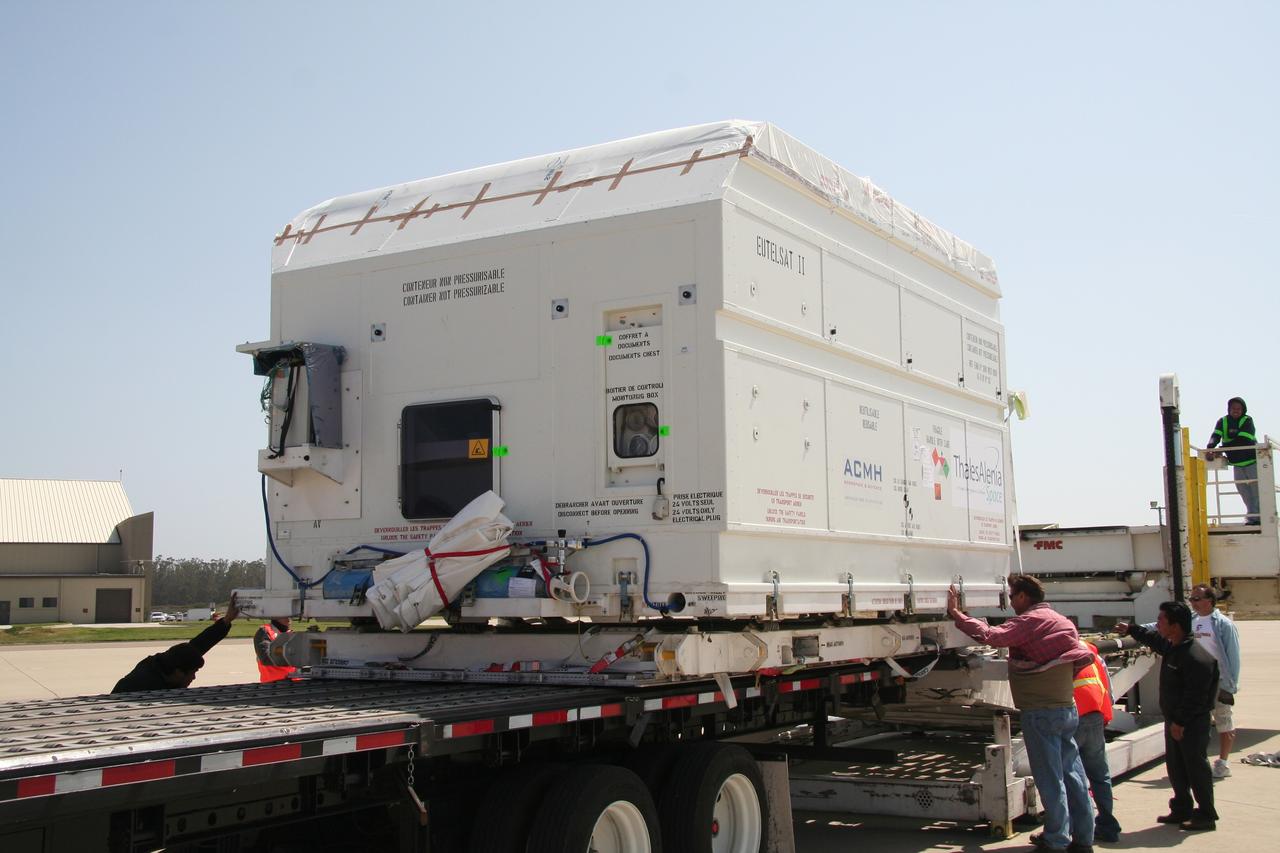 VANDENBERG AIR FORCE BASE, Calif.  –   Workers check the shipping container holding the OSTM/Jason-2 satellite after its placement on the flatbed truck at Vandenberg Air Force Base.  The satellite will be transported to the Astrotech processing facility.  The OSTM, or Ocean Topography Mission, on the Jason-2 satellite is a follow-on to Jason-1. It will take oceanographic studies of sea surface height into an operational mode for continued climate forecasting research and science and industrial applications.  This satellite altimetry data will help determine ocean circulation, climate change and sea-level rise. OSTM is a joint effort by the National Oceanic and Atmospheric Administration, NASA, France’s Centre National d’Etudes Spatiales and the European Meteorological Satellite Organisation. OSTM/Jason-2 will be launched aboard a United Launch Alliance Delta II 7320 from Vandenberg on June 15. Photo credit: NASA/Steve Greenberg, JPL