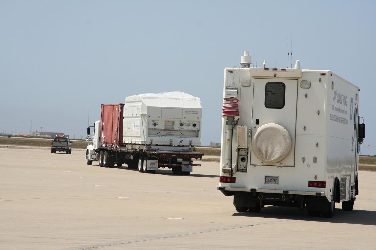 VANDENBERG AIR FORCE BASE, Calif.  –    The OSTM/Jason-2 satellite is transported from the airstrip at Vandenberg Air Force Base.  The satellite will be taken to the Astrotech processing facility.  The OSTM, or Ocean Topography Mission, on the Jason-2 satellite is a follow-on to Jason-1. It will take oceanographic studies of sea surface height into an operational mode for continued climate forecasting research and science and industrial applications.  This satellite altimetry data will help determine ocean circulation, climate change and sea-level rise. OSTM is a joint effort by the National Oceanic and Atmospheric Administration, NASA, France’s Centre National d’Etudes Spatiales and the European Meteorological Satellite Organisation. OSTM/Jason-2 will be launched aboard a United Launch Alliance Delta II 7320 from Vandenberg on June 15. Photo credit: NASA/Steve Greenberg, JPL