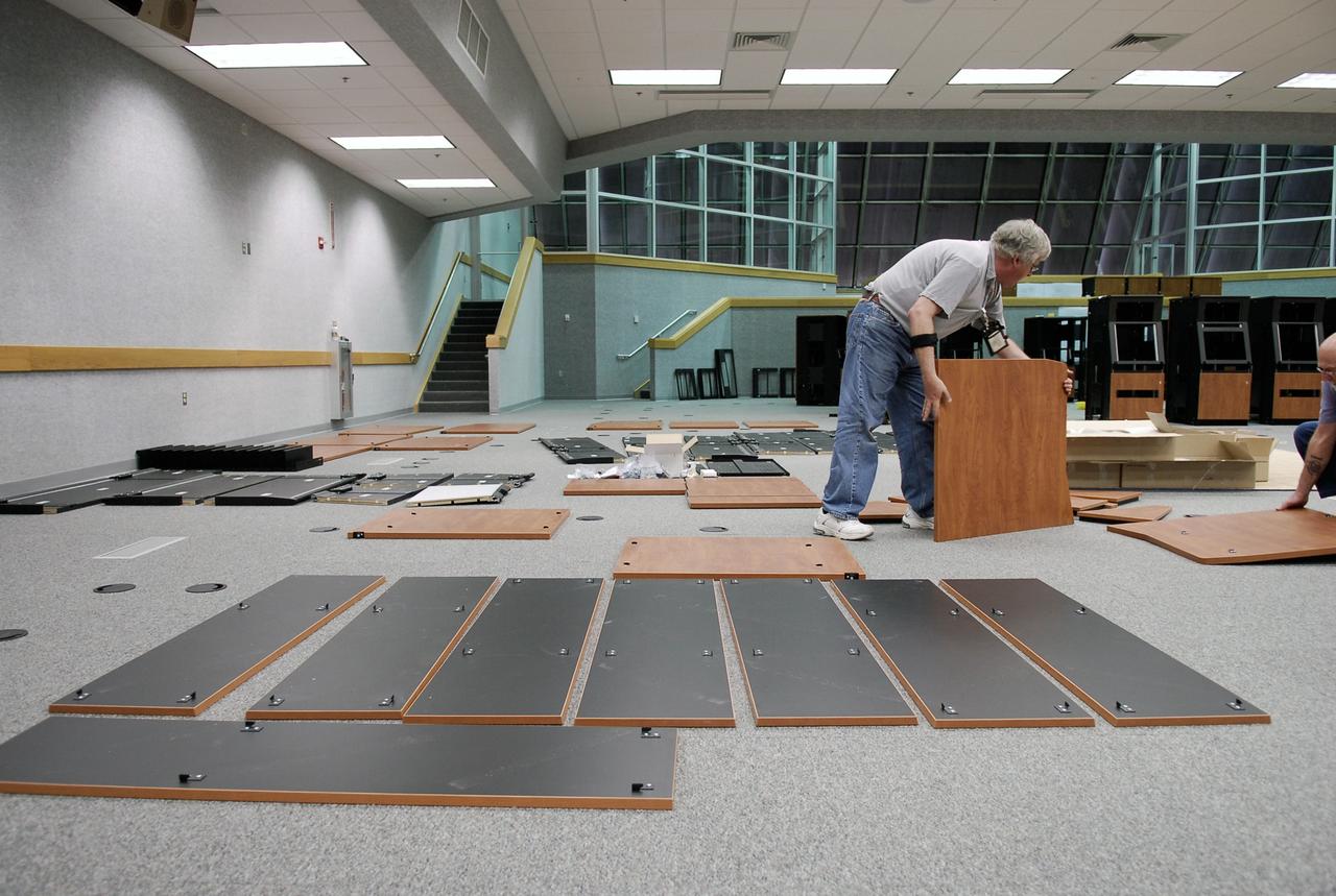 CAPE CANAVERAL, Fla. -- In Firing Room No. 1 in the Launch Control Center at NASA's Kennedy Space Center, a worker maneuvers a panel to build another cabinet to hold equipment that will support the future Ares rocket launches as part of the Constellation Program. Future astronauts will ride to orbit on Ares I, which uses a single five-segment solid rocket booster, a derivative of the space shuttle's solid rocket booster, for the first stage. Ares will be launched from Pad 39B, which is being reconfigured from supporting space shuttle launches. The Launch Control Center firing rooms face the launch pads. Photo credit: NASA/Kim Shiflett