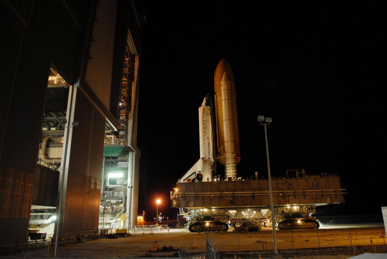 CAPE CANAVERAL, Fla. -- Getting ready for the STS-124 mission, space shuttle Discovery, atop a mobile launch platform, moves through the doors of the Vehicle Assembly Building toward Launch Pad 39A at NASA's Kennedy Space Center.  The 3.4-mile journey from the Vehicle Assembly Building began at 11:47 p.m. on May 2. After arriving at the pad, the shuttle was secured, or hard down, at 6:06 a.m. EDT May 3.  On the 13-day mission, Discovery and its crew will deliver the Japan Aerospace Exploration Agency's Japanese Experiment Module – Pressurized Module and the Japanese Remote Manipulator System. Launch is targeted for May 31.  Photo credit: NASA/Troy Cryder