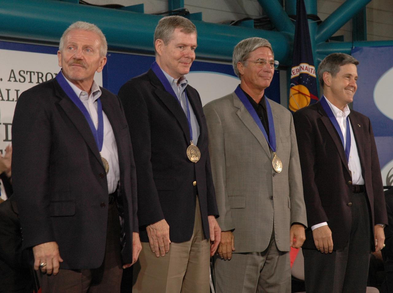 CAPE CANAVERAL, Fla. -- The new inductees into the U.S. Astronaut Hall of Fame stand for an ovation during the ceremony May 3 at NASA's Kennedy Space Center. From left are Loren Shriver; Bryan O'Connor, NASA's chief of Safety and Mission Assurance at NASA Headquarters in Washington; John Blaha; and Robert Cabana, center director of NASA's Stennis Space Center in Mississippi. Other former astronauts attending included Scott Carpenter, John Young, Bob Crippen, and Walt Cunningham. The U.S. Astronaut Hall of Fame is operated by Kennedy Space Center Visitor Complex on behalf of NASA. CNN correspondent John Zarrella hosted the event.