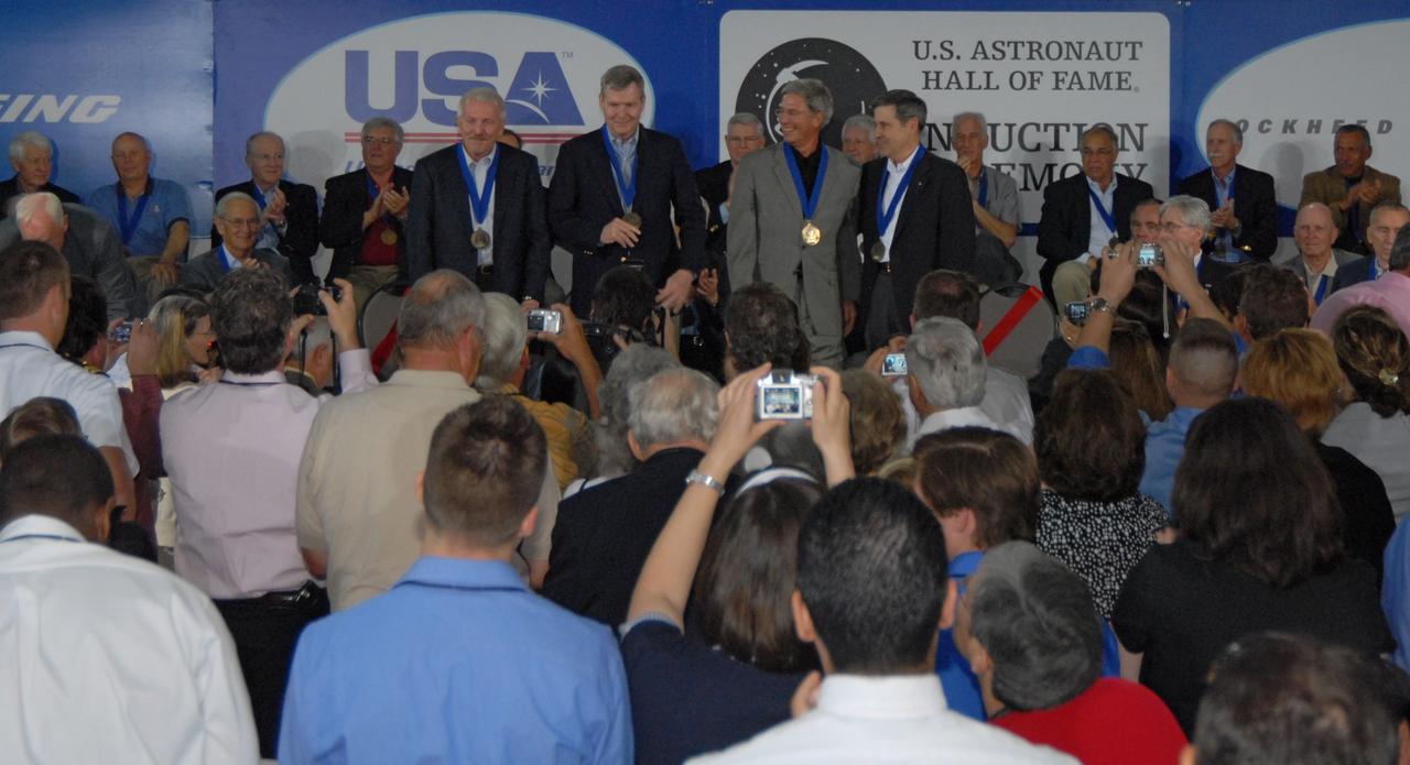 CAPE CANAVERAL, Fla. -- The new inductees into the U.S. Astronaut Hall of Fame step forward on stage for photographs following their induction. From left are Loren Shriver; Bryan O'Connor, NASA's chief of Safety and Mission Assurance at NASA Headquarters in Washington; John Blaha; and Robert Cabana, center director of NASA's Stennis Space Center in Mississippi. The ceremony was held May 3 at NASA's Kennedy Space Center. Other former astronauts attending included Scott Carpenter, John Young, Bob Crippen, and Walt Cunningham. The U.S. Astronaut Hall of Fame is operated by Kennedy Space Center Visitor Complex on behalf of NASA. CNN correspondent John Zarrella hosted the event.