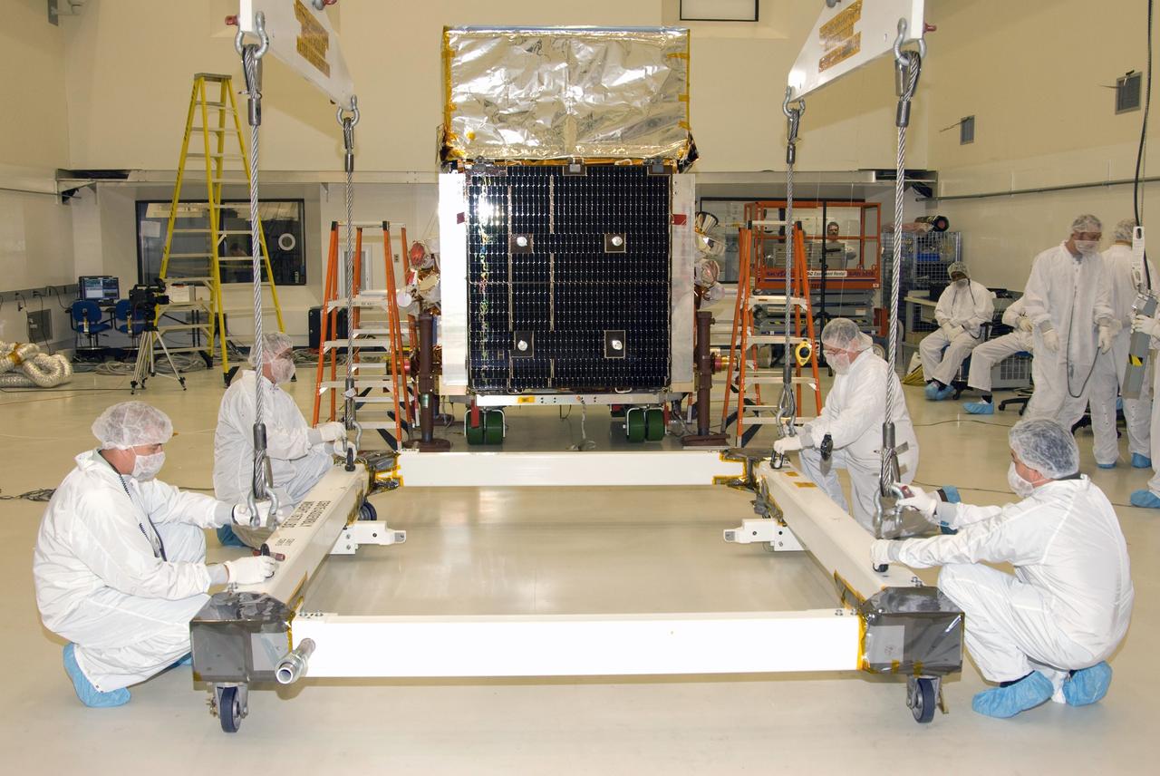 CAPE CANAVERAL, Fla. --   At the Astrotech payload processing facility in Titusville, Fla., technicians attach the cables to the overhead crane that will be used to lift  NASA's Gamma-ray Large Area Space Telescope, or GLAST, spacecraft.  The spacecraft is being prepared for its move to the Hazardous Processing Facility for fueling.  The GLAST is a powerful space observatory that will explore the universe's ultimate frontier, where nature harnesses forces and energies far beyond anything possible on Earth;  probe some of science's deepest questions, such as what our Universe is made of, and search for new laws of physics; explain how black holes accelerate jets of material to nearly light speed; and help crack the mystery of stupendously powerful explosions known as gamma-ray bursts. A launch date is still to be determined.  Photo credit: NASA/Mike Kerley