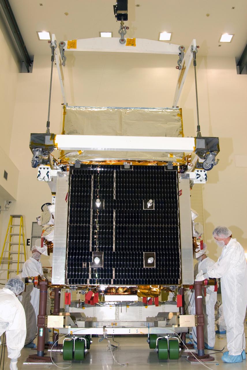 CAPE CANAVERAL, Fla. --  At the Astrotech payload processing facility in Titusville, Fla., the overhead crane continues to lower NASA's Gamma-ray Large Area Space Telescope, or GLAST, spacecraft onto the transporter. The spacecraft is being prepared for its move to the Hazardous Processing Facility for fueling. The GLAST is a powerful space observatory that will explore the universe's ultimate frontier, where nature harnesses forces and energies far beyond anything possible on Earth;  probe some of science's deepest questions, such as what our Universe is made of, and search for new laws of physics; explain how black holes accelerate jets of material to nearly light speed; and help crack the mystery of stupendously powerful explosions known as gamma-ray bursts. A launch date is still to be determined.  Photo credit: NASA/Mike Kerley