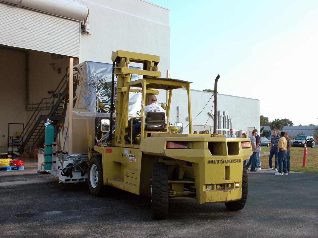 CAPE CANAVERAL, Fla. --   NASA's Gamma-ray Large Area Space Telescope, or GLAST, spacecraft is moved out of the Astrotech payload processing facility in Titusville, Fla.  It is being transported to the Hazardous Processing Facility for fueling.  The GLAST is a powerful space observatory that will explore the Universe's ultimate frontier, where nature harnesses forces and energies far beyond anything possible on Earth;  probe some of science's deepest questions, such as what our Universe is made of, and search for new laws of physics; explain how black holes accelerate jets of material to nearly light speed; and help crack the mystery of stupendously powerful explosions known as gamma-ray bursts. A launch date still is to be determined. Photo credit: NASA/Jim Grossmann