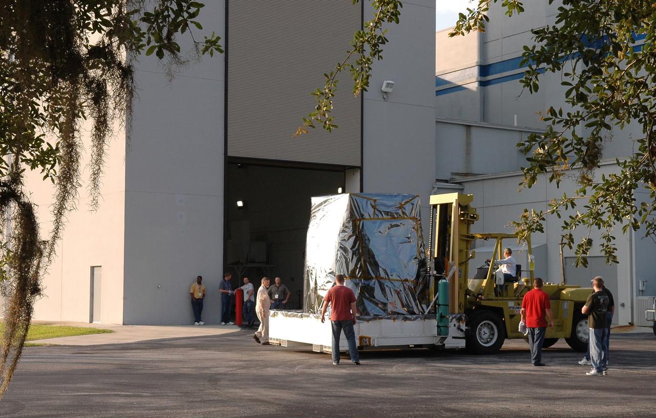 CAPE CANAVERAL, Fla. --  NASA's Gamma-ray Large Area Space Telescope, or GLAST, spacecraft is moved toward the Hazardous Processing Facility for fueling. The GLAST is a powerful space observatory that will explore the Universe's ultimate frontier, where nature harnesses forces and energies far beyond anything possible on Earth;  probe some of science's deepest questions, such as what our Universe is made of, and search for new laws of physics; explain how black holes accelerate jets of material to nearly light speed; and help crack the mystery of stupendously powerful explosions known as gamma-ray bursts. A launch date still is to be determined. Photo credit: NASA/Jim Grossmann