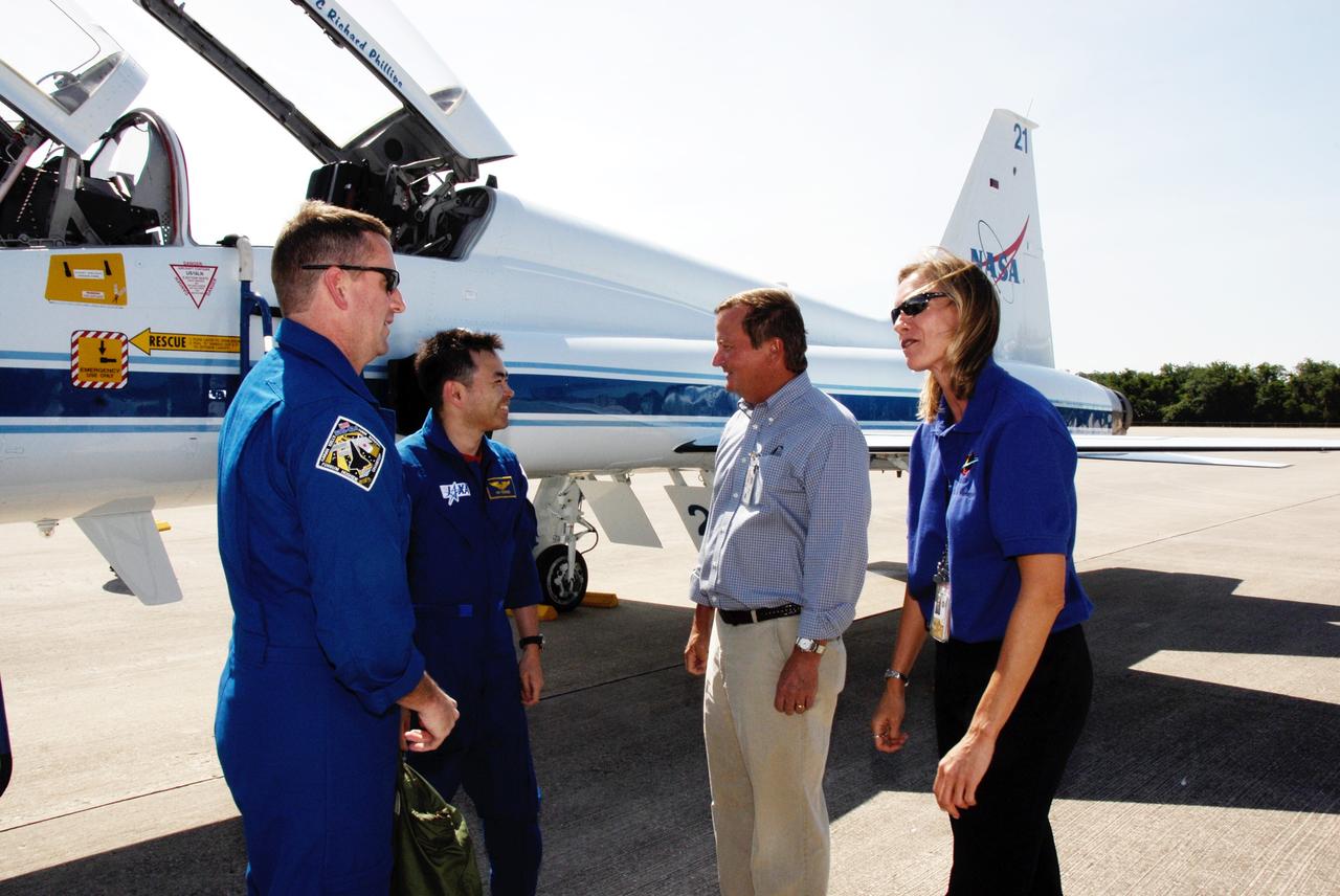 CAPE CANAVERAL, Fla. --  The crew of space shuttle Discovery's STS-124 mission arrive at NASA Kennedy Space Center's Shuttle Landing Facility to take part in the Terminal Countdown Demonstration Test, or TCDT.  Next to the T-38 jet aircraft are Pilot Ken Ham (left)  and Mission Specialist Akihiko Hoshide. They are greeted at right by Mike Leinbach, shuttle launch director, and Stephanie Stilson, NASA Flow Director for Discovery. TCDT is a rehearsal for launch that includes practicing emergency procedures, handling on-orbit equipment, and simulating a launch countdown. On the STS-124 mission, the crew will deliver and install the Japanese Experiment Module – Pressurized Module and Japanese Remote Manipulator System.  Discovery's launch is targeted for May 31.  Photo credit: NASA/Kim Shiflett