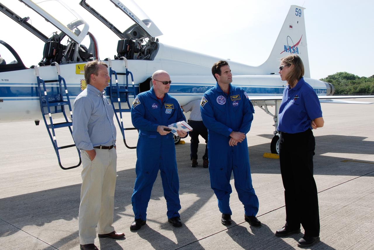 CAPE CANAVERAL, Fla. --   The crew of space shuttle Discovery's STS-124 mission arrive at NASA Kennedy Space Center's Shuttle Landing Facility to take part in the Terminal Countdown Demonstration Test, or TCDT. Here, Commander Mark Kelly (center left) and Mission Specialist Greg Chamitoff (center right) are greeted by Shuttle Launch Director Mike Leinbach (far left) and NASA Flow Director for Discovery Stephanie Stilson.  TCDT is a rehearsal for launch that includes practicing emergency procedures, handling on-orbit equipment, and simulating a launch countdown. On the STS-124 mission, the crew will deliver and install the Japanese Experiment Module – Pressurized Module and Japanese Remote Manipulator System.  Discovery's launch is targeted for May 31.  Photo credit: NASA/Kim Shiflett