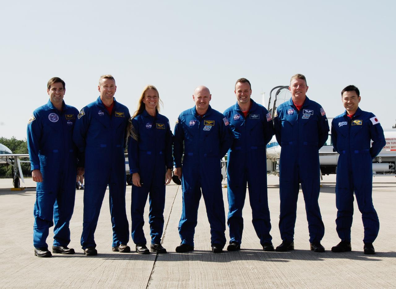 CAPE CANAVERAL, Fla. -- After their arrival at NASA Kennedy Space Center's Shuttle Landing Facility, the crew of space shuttle Discovery's STS-124 mission gather for a group photo. The crew is at Kennedy to take part in the Terminal Countdown Demonstration Test, or TCDT. From left are Mission Specialist Greg Chamitoff, Pilot Ken Ham, Mission Specialist Karen Nyberg, Commander Mark Kelly and Mission Specialists Ron Garan, Mike Fossum and Akihiko Hoshide, who represents the Japan Aerospace Exploration Agency, or JAXA. TCDT is a rehearsal for launch that includes practicing emergency procedures, handling on-orbit equipment, and simulating a launch countdown. On the STS-124 mission, the crew will deliver and install the Japanese Experiment Module – Pressurized Module and Japanese Remote Manipulator System. Discovery's launch is targeted for May 31. Photo credit: NASA/Kim Shiflett