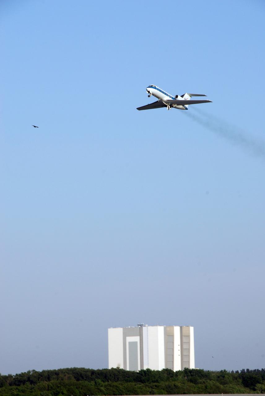 CAPE CANAVERAL, Fla. -- NASA's Shuttle Training Aircraft, or STA, soars into the sky from the NASA Kennedy Space Center Shuttle Landing Facility with STS-124 Commander Mark Kelly or Pilot Ken Ham at the controls. Below is the Vehicle Assembly Building. Kelly and Ham are practicing space shuttle landings. The STA is a Grumman American Aviation-built Gulf Stream II jet that was modified to simulate an orbiter's cockpit, motion and visual cues, and handling qualities. In flight, the STA duplicates the orbiter's atmospheric descent trajectory from approximately 35,000 feet altitude to landing on a runway. Because the orbiter is unpowered during re-entry and landing, its high-speed glide must be perfectly executed the first time. The crew for space shuttle Discovery's STS-124 mission is at Kennedy for a full launch dress rehearsal, known as the terminal countdown demonstration test, or TCDT. Providing astronauts and ground crews with an opportunity to participate in various simulated countdown activities, TCDT includes equipment familiarization and emergency training. Discovery's launch is targeted for May 31. Photo credit: NASA/Kim Shiflett