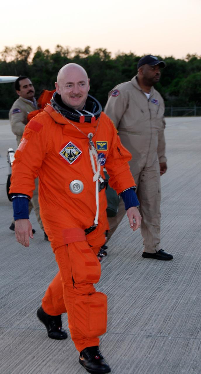 CAPE CANAVERAL, Fla. -- Back at the NASA Kennedy Space Center Shuttle Landing Facility, STS-124 Commander Mark Kelly happily crosses the parking area after the successful space shuttle landing practice aboard NASA's Shuttle Training Aircraft, or STA. The STA is a Grumman American Aviation-built Gulf Stream II jet that was modified to simulate an orbiter's cockpit, motion and visual cues, and handling qualities. In flight, the STA duplicates the orbiter's atmospheric descent trajectory from approximately 35,000 feet altitude to landing on a runway. Because the orbiter is unpowered during re-entry and landing, its high-speed glide must be perfectly executed the first time. The crew for space shuttle Discovery's STS-124 mission is at Kennedy for a full launch dress rehearsal, known as the terminal countdown demonstration test, or TCDT. Providing astronauts and ground crews with an opportunity to participate in various simulated countdown activities, TCDT includes equipment familiarization and emergency training. Discovery's launch is targeted for May 31. Photo credit: NASA/Kim Shiflett