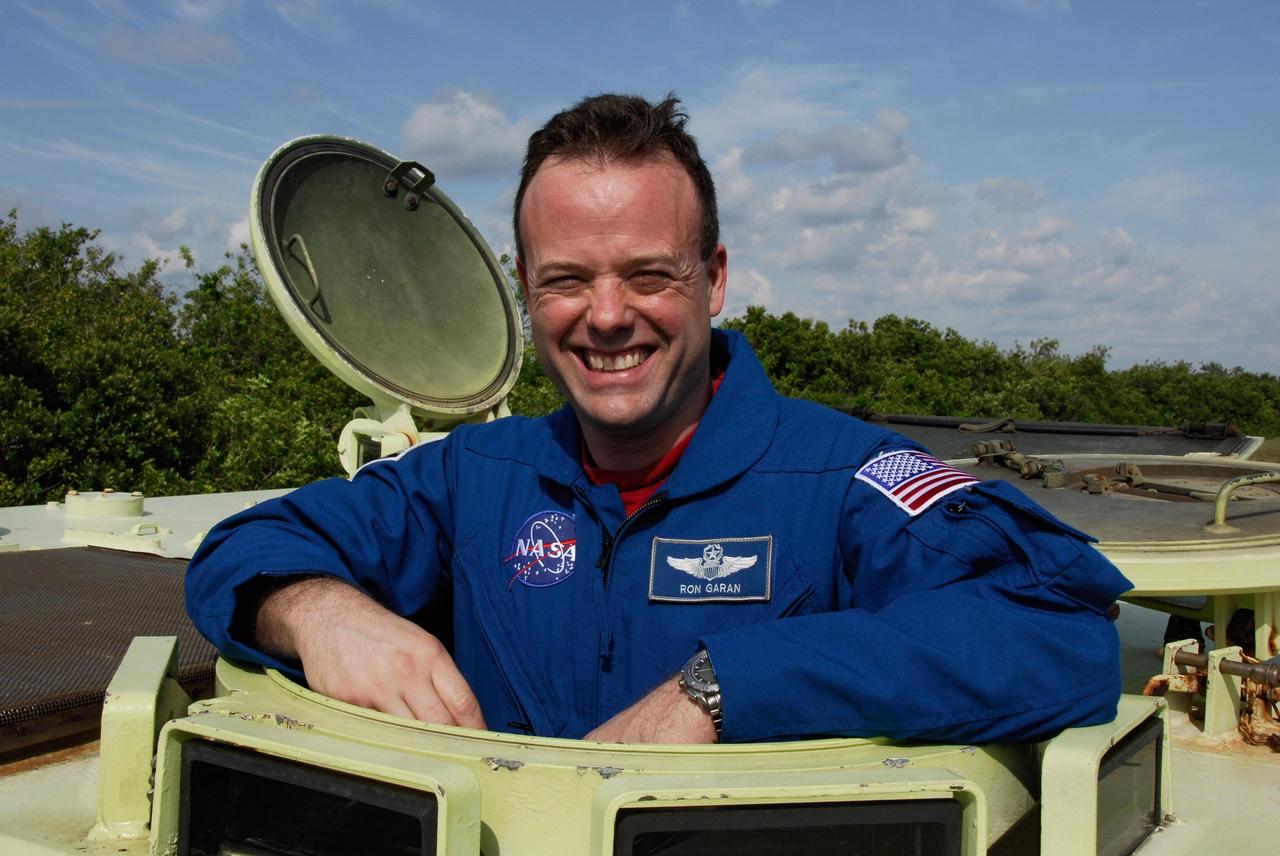 CAPE CANAVERAL, Fla. -- STS-124 Mission Specialist Ron Garan is pleased with his driving practice in the M113 armored personnel carrier, part of emergency training. He and other crew members are at NASA's Kennedy Space Center for a dress launch rehearsal called the terminal countdown demonstration test. TCDT provides astronauts and ground crews with an opportunity to participate in various simulated countdown activities, including equipment familiarization and emergency training. On the STS-124 mission, the crew will deliver and install the Japanese Experiment Module – Pressurized Module and Japanese Remote Manipulator System. Discovery's launch is targeted for May 31. Photo credit: NASA/Kim Shiflett