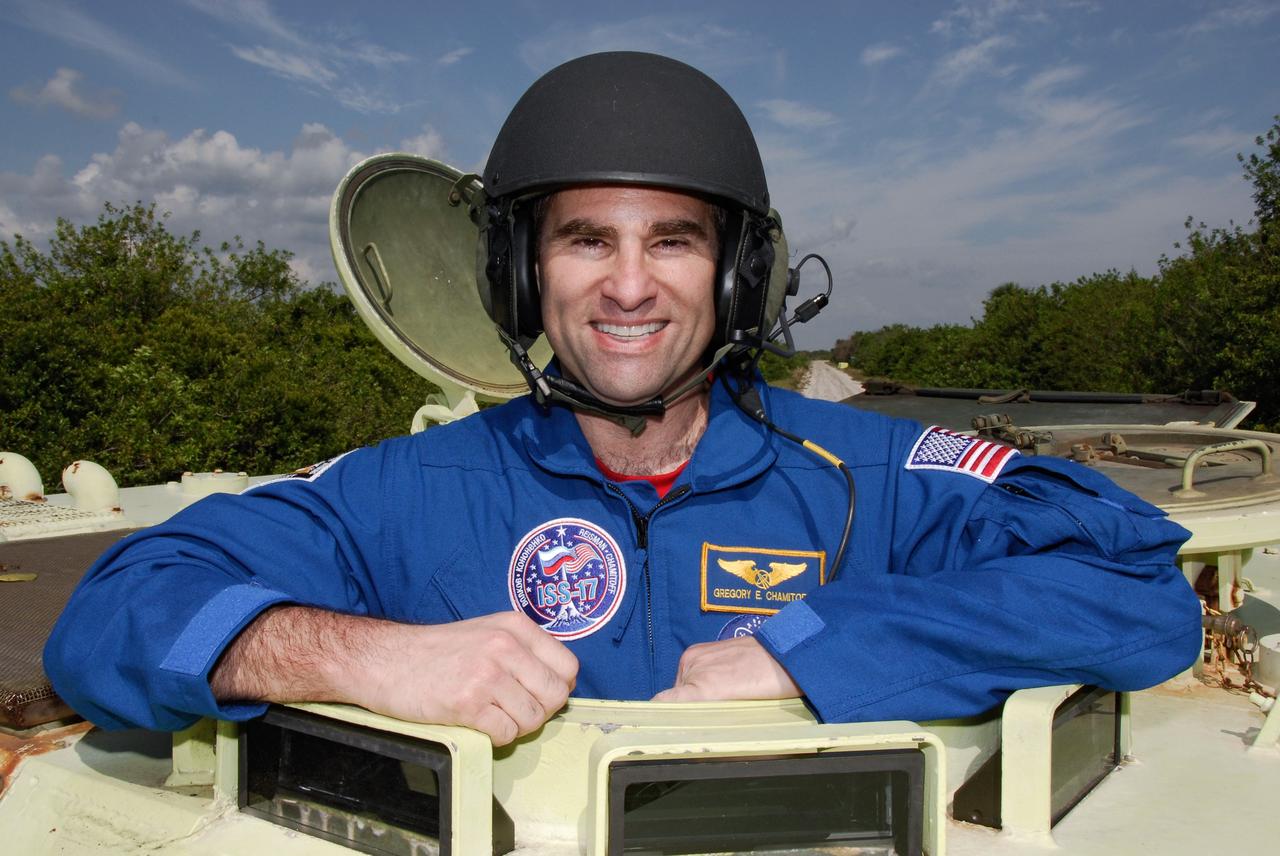 CAPE CANAVERAL, Fla. -- STS-124 Mission Specialist Greg Chamitoff stands ready to practice driving the M113 armored personnel carrier as part of emergency training. He and other crew members are at NASA's Kennedy Space Center for a dress launch rehearsal called the terminal countdown demonstration test. TCDT provides astronauts and ground crews with an opportunity to participate in various simulated countdown activities, including equipment familiarization and emergency training. On the STS-124 mission, the crew will deliver and install the Japanese Experiment Module – Pressurized Module and Japanese Remote Manipulator System. Discovery's launch is targeted for May 31. Photo credit: NASA/Kim Shiflett