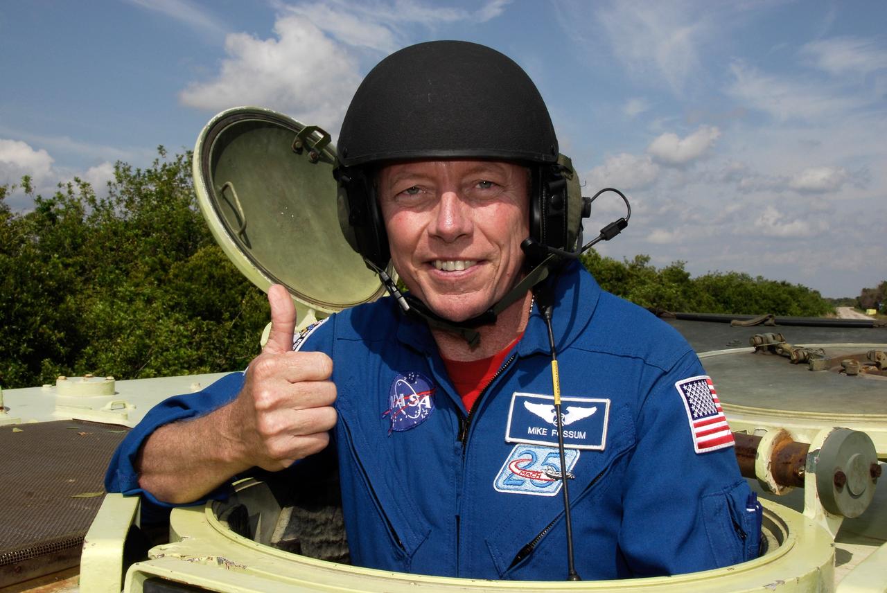 CAPE CANAVERAL, Fla. -- STS-124 Mission Specialist Mike Fossum stands ready to practice driving the M113 armored personnel carrier as part of emergency training. He and other crew members are at NASA's Kennedy Space Center for a dress launch rehearsal called the terminal countdown demonstration test. TCDT provides astronauts and ground crews with an opportunity to participate in various simulated countdown activities, including equipment familiarization and emergency training. On the STS-124 mission, the crew will deliver and install the Japanese Experiment Module – Pressurized Module and Japanese Remote Manipulator System. Discovery's launch is targeted for May 31. Photo credit: NASA/Kim Shiflett