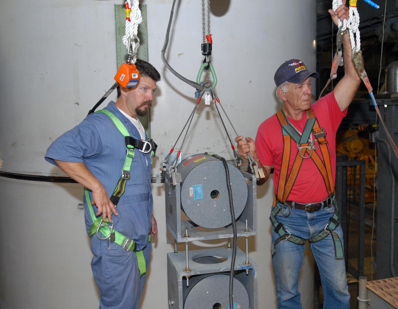 CAPE CANAVERAL, Fla. -- Vibration and laser testing is being conducted on Ares I-X segments at NASA's Kennedy Space Center, team members (left to right) Michael Gillenwater and Joe Lucas configure the two, 250-hp Shaker Units that provide known input levels into the test article. Photo credit: NASA/Dimitri Gerondidakis