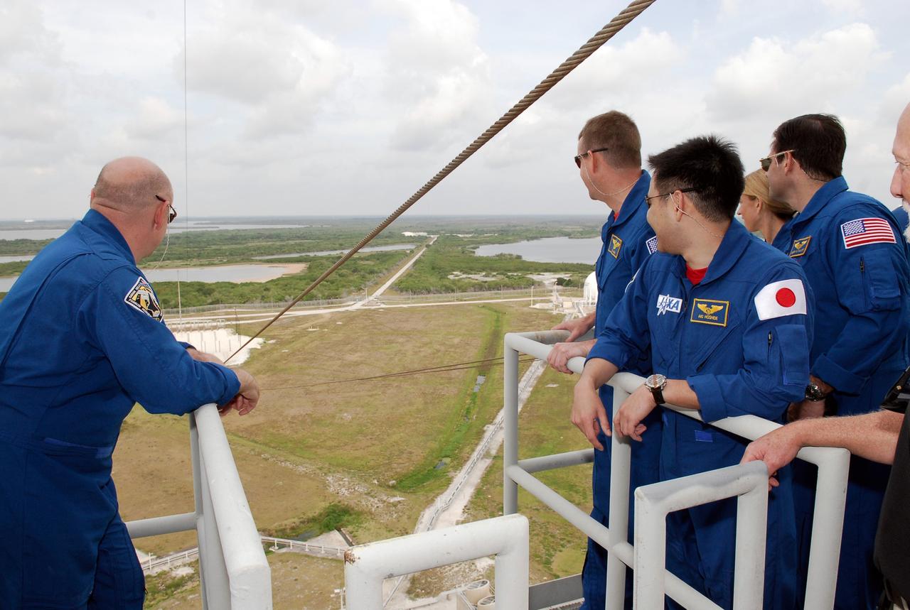 CAPE CANAVERAL, Fla. --  On Launch Pad 39A at NASA's Kennedy Space Center, the STS-124 crew looks at the action of the slidewire basket used to exit the fixed service structure in the event of an emergency. At left is Commander Mark Kelly.  At right are Pilot Ken Ham and Mission Specialists Akihiko Hoshide, Karen Nyberg and Greg Chamitoff.   Not seen are Mission Specialists Ron Garan and Mike Fossum. Hoshide represents the Japan Aerospace Exploration Agency.  The crew is at Kennedy for a dress launch rehearsal called the terminal countdown demonstration test. TCDT provides astronauts and ground crews with an opportunity to participate in various simulated countdown activities, including equipment familiarization and emergency training.  On the STS-124 mission, the crew will deliver and install the Japanese Experiment Module – Pressurized Module and Japanese Remote Manipulator System.  Discovery's launch is targeted for May 31.   Photo credit: NASA/Kim Shiflett