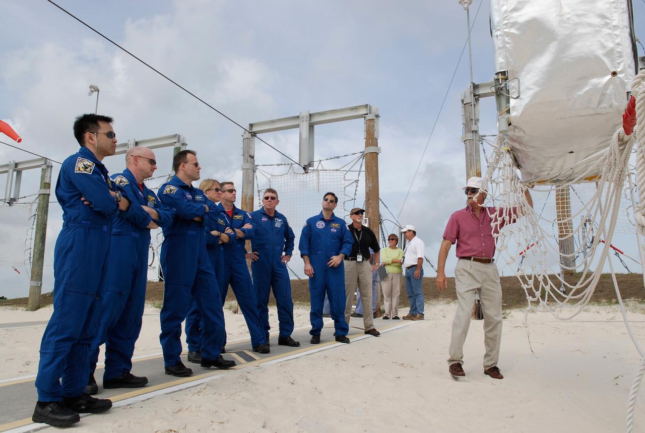 CAPE CANAVERAL, Fla. --  In the slidewire basket area of Launch Pad 39A at NASA's Kennedy Space Center, the STS-124 crew gets instruction about landing safely.  Lined up from left are Mission Specialist Akihiko Hoshide, Commander Mark Kelly, Mission Specialists Ron Garan and Karen Nyberg, Pilot Ken Ham, and Mission Specialists Mike Fossum and Greg Chamitoff. Hoshide represents the Japan Aerospace Exploration Agency.  The crew is at Kennedy for a dress launch rehearsal called the terminal countdown demonstration test. TCDT provides astronauts and ground crews with an opportunity to participate in various simulated countdown activities, including equipment familiarization and emergency training.  On the STS-124 mission, the crew will deliver and install the Japanese Experiment Module – Pressurized Module and Japanese Remote Manipulator System.  Discovery's launch is targeted for May 31.   Photo credit: NASA/Kim Shiflett